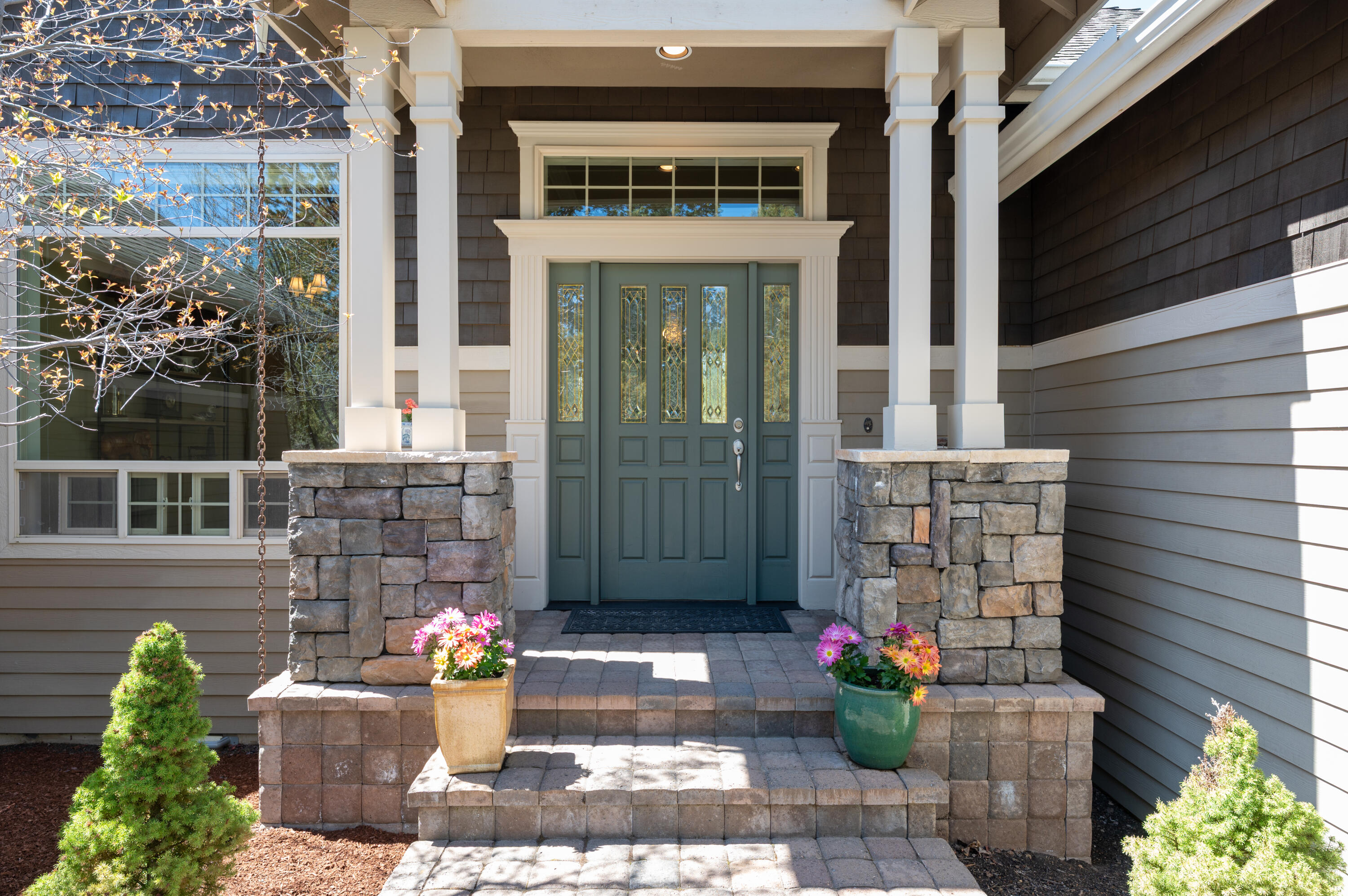 Located in the prestigious Awbrey Glen Golf Course community, this single-level home by Dave Hasenoehrl blends comfort and class. A welcoming entry leads to a spacious living area with wood floors, abundant windows, and a stone-surround fireplace. The large kitchen features granite tile counters, updated charcoal grey appliances, double ovens, pantry, breakfast bar, and an eating nook overlooking the serene backyard & natural common area. The primary suite, with a walk-in closet & spacious bathroom is privately situated away from two guest bedrooms and baths. Separate laundry with sink. Room for storage in the attached oversized 2-car garage. Outdoor living shines with a large partially covered deck and a lower paver patio framed by new, low-maintenance landscaping. Residents may opt into the renowned Awbrey Glen Golf Club, offering a pool, restaurant, and more. This gated westside Bend neighborhood provides easy access to schools, shopping, excellent outdoor recreation, and downtown.