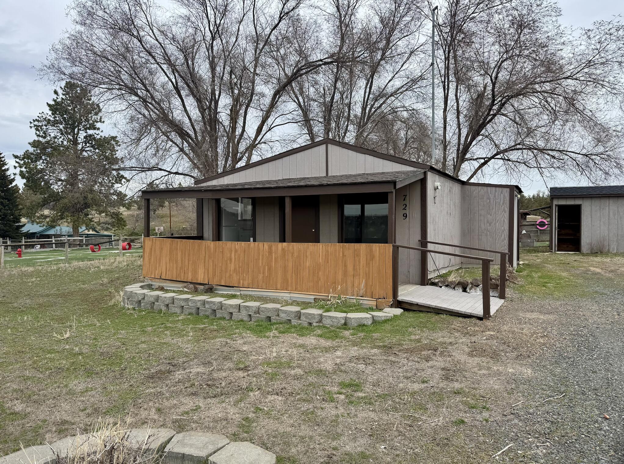 Rare Opportunity in the Heart of Madras! Situated on a full acre within city limits, this charming 2-bedroom, 1-bath home offers unique potential for the savvy buyer or investor. The home features a dedicated laundry area, two storage buildings, and has been well loved over the years. Whether you're looking for a project home to make your own or exploring development possibilities, this property holds exciting promise. Check with the City of Madras regarding potential to subdivide. Please note: the home does not have a permanent foundation and will not qualify for traditional financing.