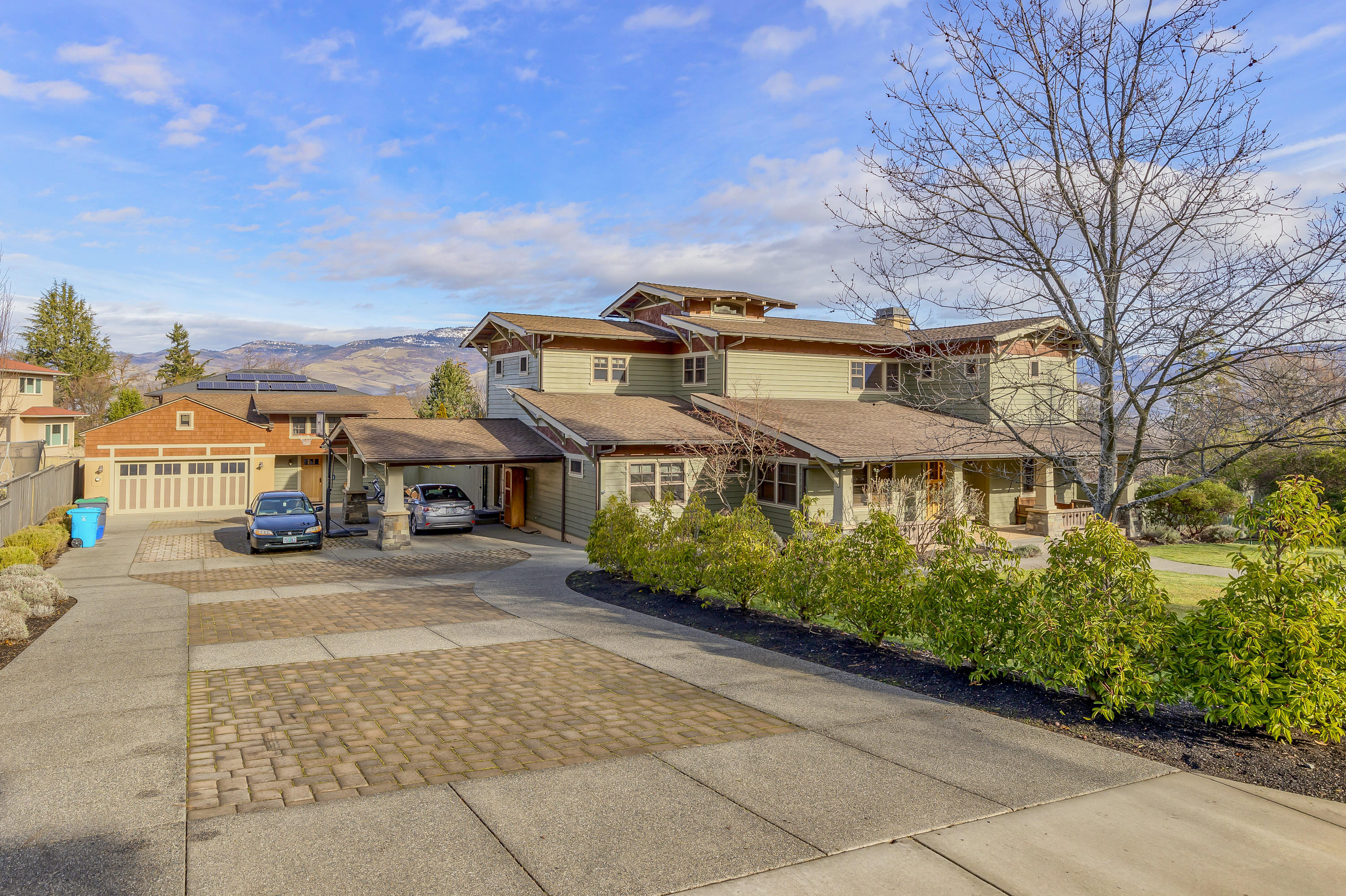 Top quality materials coupled with an artistic flair, this custom built Craftsman style home exudes warmth and charm throughout. Main home features 5 beds, 3 baths and over 4,000 SF. There is also a 475+ SF detached guest space for overflow living. Gourmet kitchen with vertical grain Fir cabinets, Corian countertops, tile backsplash + adjacent mudroom with sink and built-ins. Master Suite offers balcony views, high ceiling, heated tile bathroom floor, 2 person jetted tub + 2-headed shower; walk-in closets in all three upstairs bedrooms. Versatile, finished basement for hanging out, working from home or both. Main level library + formal living room w/ fireplace. Outdoor entertaining is a dream; expansive hardscaping, stone patio with seating wall, newer deck with sunken hot tub, paver driveway, small orchard and usable .50 acre lot complete with TID irrigation. Detached 715 SF, garage with ample storage. Expansive views of Grizzly Peak and close proximity to town.