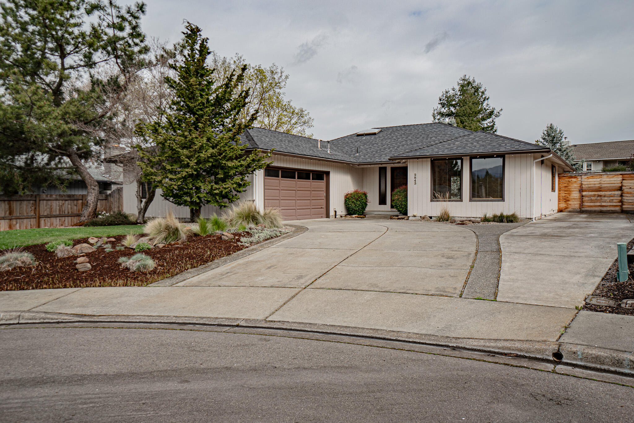 This charming single-level home is nestled in a peaceful cul-de-sac within the desirable Lone Pine School District. Boasting an inviting open floor plan, the residence has natural light, which accentuates its vaulted ceilings and updated features. A focal point of the living space is a cozy brick fireplace, complemented by built-in bookshelves. The home is adorned with tasteful updates, including modern colors and fixtures. Outside, the low-maintenance yard is a serene retreat, complete with a tranquil fish pond and waterfall. Conveniently, there is ample space for an RV or boat, with easy access.