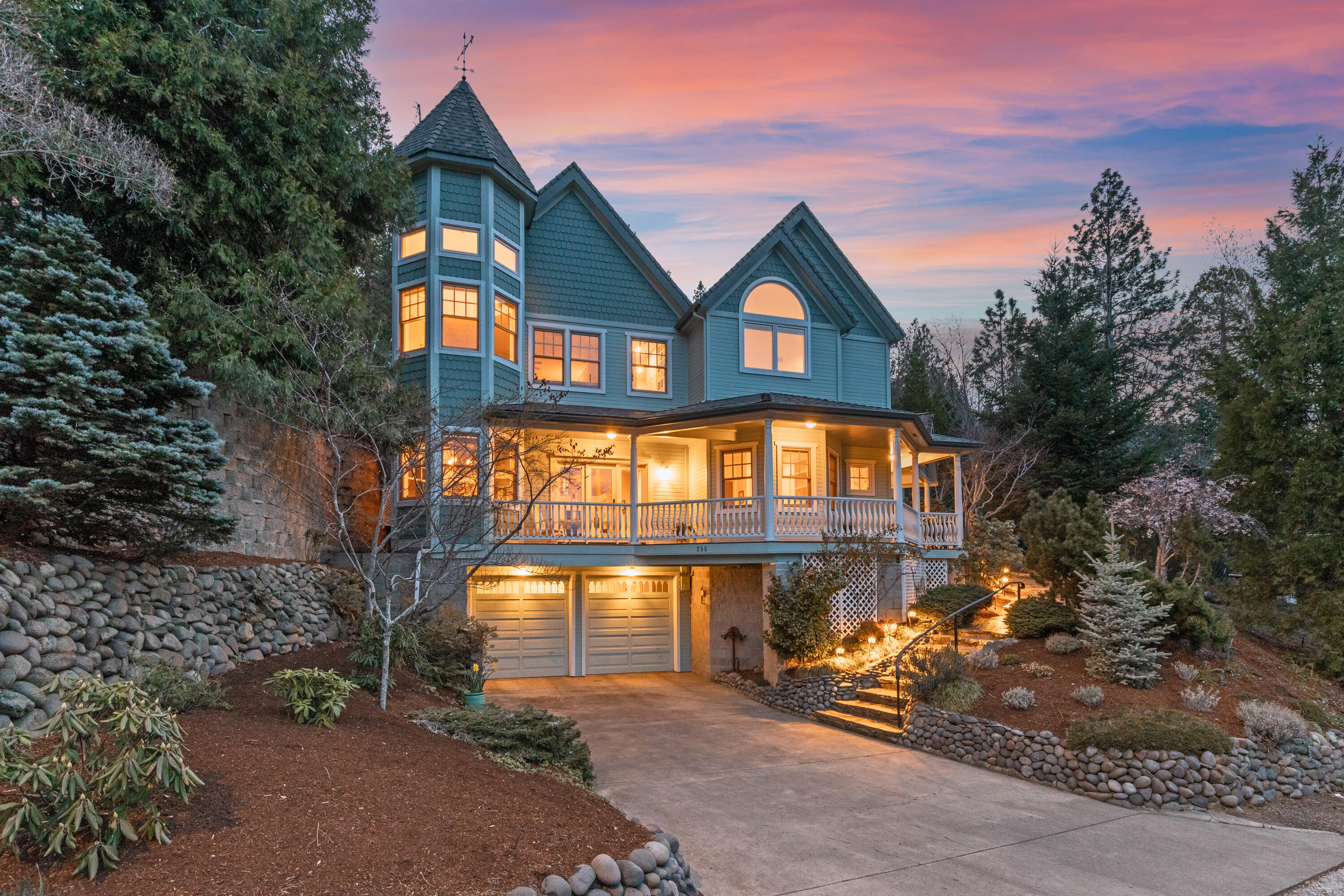Custom Victorian home in Ashland Historic District, designed and built by Carlos Reichenshammer,  just blocks from Lithia Park. Marble floor entry to formal living room has vaulted ceiling, plush bench seating and fireplace. Enjoy entertaining in formal dining room with built in cabinetry. Huge country French kitchen boasts granite countertops, two islands, Thermadore 5 burner cooktop, double Bosch ovens and glass paned cabinets. Kitchen opens to family room with fireplace and breakfast nook. Majestic oak stairway leads to office/library and guest bedroom with walk-in closet and en suite bath. Primary suite has fireplace,2 walk in closets and bathroom with soaking tub and shower. Mountain views throughout. Custom 650 bottle wine cellar features travertine walls and floors. Courtyard water fountain, large front wrap around porch and back deck complete the outdoor amenities