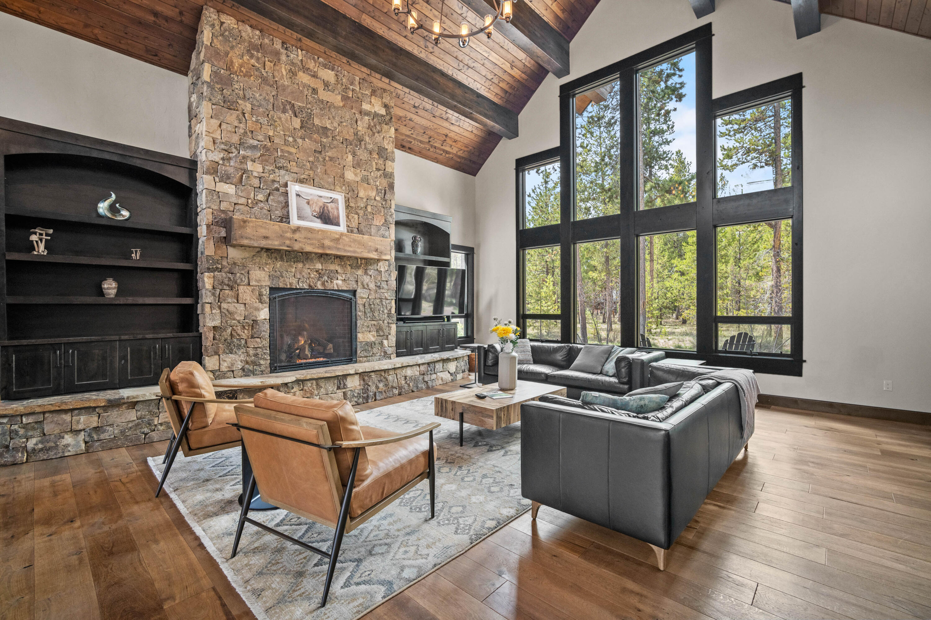 Timeless Caldera Springs design welcomes you with a grand, trussed entryway and stacked stone bases. The Great Room boasts stunning floor-to-ceiling windows offering panoramic views of the expansive common area. Rich, dark wood and massive stone fireplace evoke a Cascadian ambiance. Entertainers will delight in the spacious kitchen/dining area with a large center island, perfect for gatherings. The ground floor features the luxurious Primary Suite, two additional suites, and a powder room, with a convenient utility room adjacent to the three-car garage. Outside, a sprawling patio with hot tub and firepit extends from the Great Room. Upstairs, discover another suite, bonus room, and bunkroom ideal for children. Exciting amenities await with the Eastern Expansion and nearing completion of the Forest House recreation center. For nearly 20 years, Caldera Springs has upheld the cherished traditions of Sunriver. Start your own traditions today in this remarkable community.