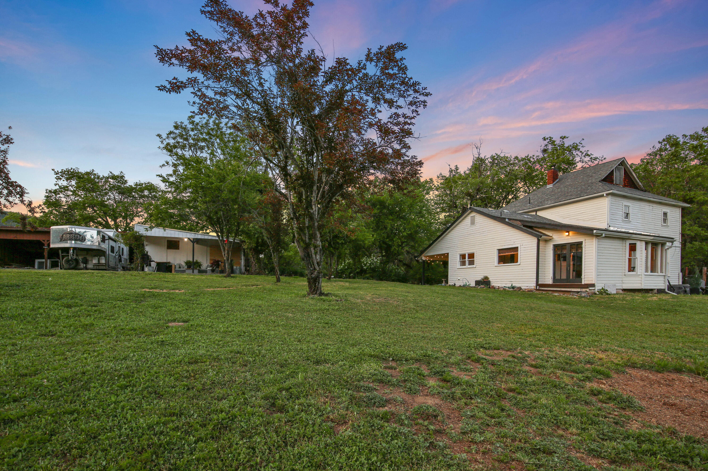 Beautifully renovated two-story farmhouse offering 4 bedrooms, 2 bathrooms, and 2,272 sq ft of living space, not including attic. Set against stunning views of Table Rock and surrounding mountains, this home features an open-concept layout, cozy living room with fireplace, durable LVP flooring, and 2 new heat pumps and furnace units. Situated on 38+ acres, the property includes two wells with a new filtration system, mature fruit and walnut trees, WiFi-enabled sprinkler and drip irrigation, a large seasonal pond, and year-round creek. Horse and livestock enthusiasts will appreciate the 40'x60' barn with four stalls with concrete floors, rubber mats, and 3 runs (with space to add more if desired) plus a 100'x200' riding arena. Additional features include a 3-car carport, workshop with concrete floors, and RV/trailer hookups.