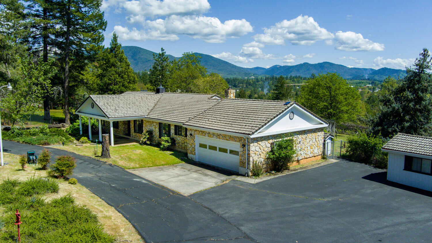 CASH ONLY- This beautiful home has major potential! Beautiful surroundings, great location, strong well at 16 gpm, smart layout and space for everything! Bring your boats, collectable cars, or toys to this 5-car setup. Thoughtful semi-open floor plan with a family room, living room, formal dining, breakfast nook, spacious kitchen, canning room (or more shop space, storage). On nearly 2 ACRES, set off a quiet street, and fully fenced and gated, and it's waiting for YOU! Featuring a wood burning fireplace, newer hardwood floors, tile roof, updated heat and air, brand new gas range, security system, utility sink, covered front porch and a graciously large covered back patio, gazebo, level lot with lovely landscaping, and so much more! 
Attached 2-car garage, detached 3-car garage, boat and RV carports, plus plenty of shop and storage space. Some ceilings and walls have been opened up for future repairs. The home will need a new roof. Many bids on file. Definite potential!