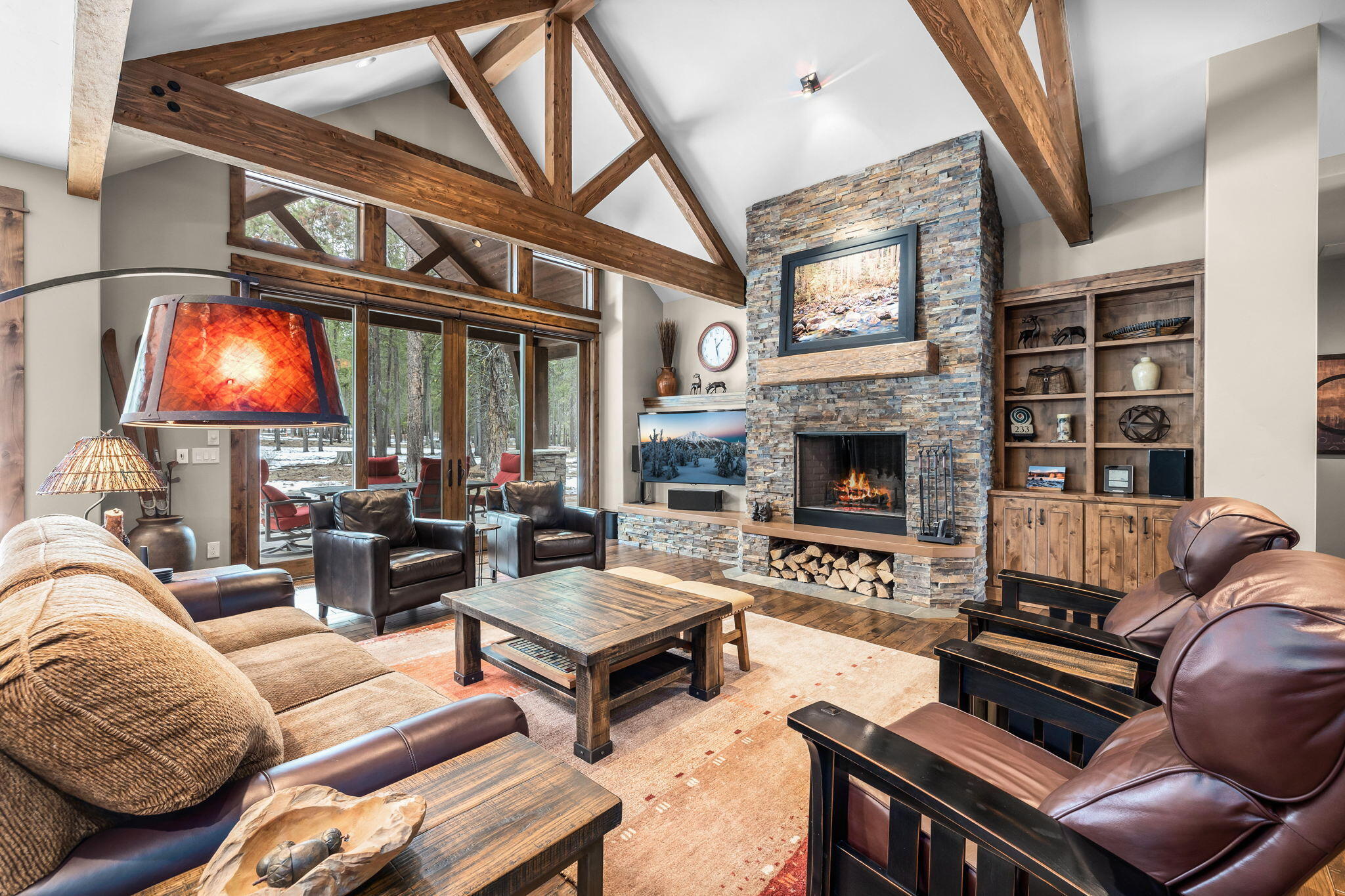 Immaculate Northwest Mountain Lodge home in Caldera Springs is privately situated on large lot with peaceful pine forest views.  Outdoor living area inc. large paver patio, firepit, dining area for hosting al fresco meals & a private hot-tub patio. Impressive craftsmanship throughout the warm & inviting interiors; hickory wood flooring leads to the great room w/ wood burning fireplace & windows overlooking the forest views.  Spacious gourmet kitchen features Thermador appliances, pantry, breakfast bar w/ prep sink & wine fridge. The main level of this gorgeous home provides a private primary suite w/ access to outdoor hot-tub patio for relaxing after a fun day of outdoor adventures. Your guests will be pampered by the accommodations in one of 2 addtl main level suites & will particularly enjoy the privacy of the 4th bedroom/bonus room & bath on 2nd level.  You will be able to take care of business in main level office & find plenty of space to store outdoor gear in oversized garage.