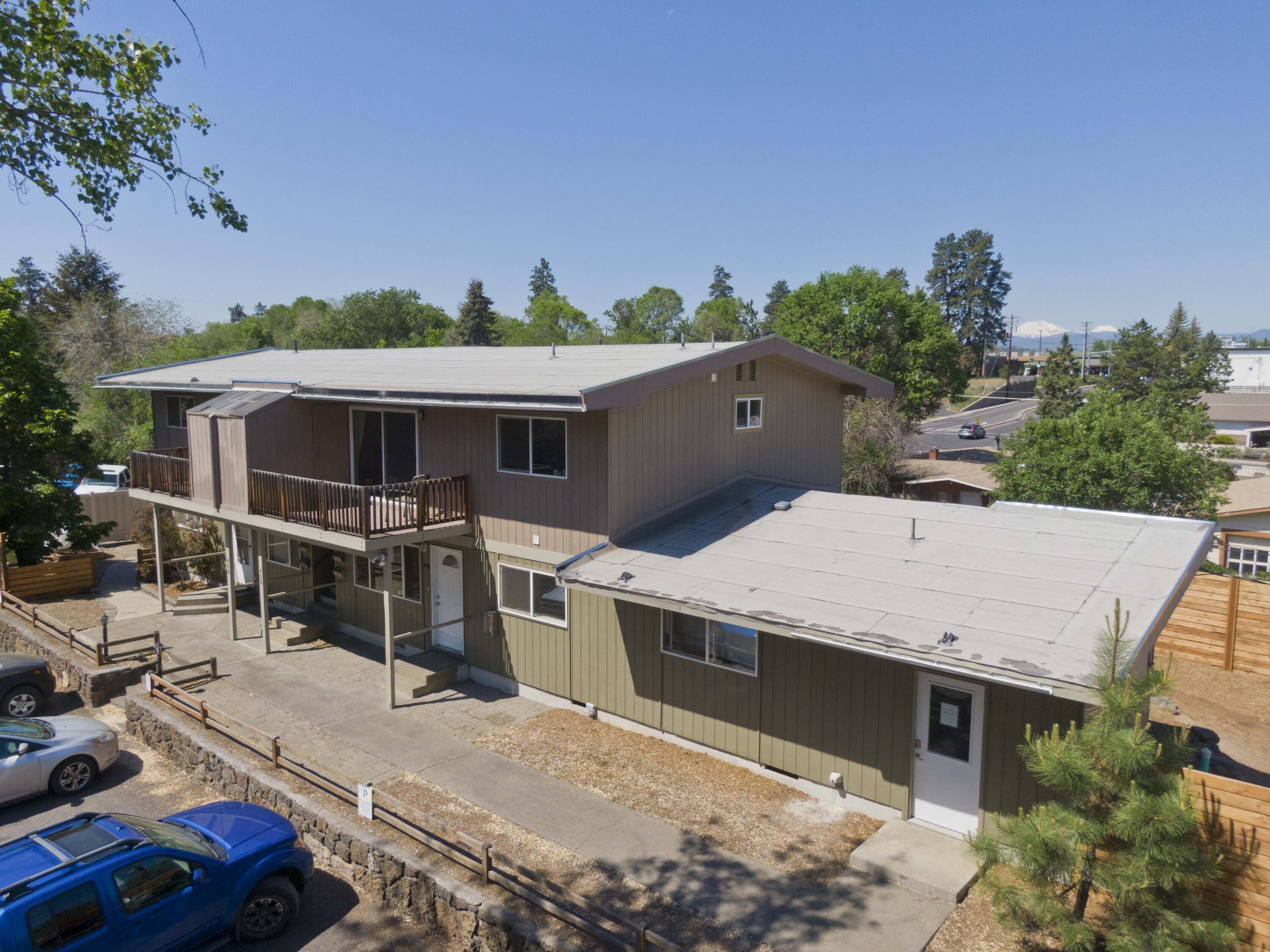'Stories Mid-Town' fourplex is situated in a prime NE Bend location just 1 mile from downtown Bend in  desirable East Mid-Town and walking distance to Pilot Butte. A desirable unit mix (Three-2 bed/1 bath & One-3 bed/2 bath) with stable income in place. Two units are thoroughly updated. Current scheduled monthly rents equal $5,600 with additional upside. Subject property has well maintained grounds with bottom units featuring sizeable fenced yards (3 bed has 9x12 shed) and upper units have patio's. Tenants enjoy common areas, community garden and on-site laundry.