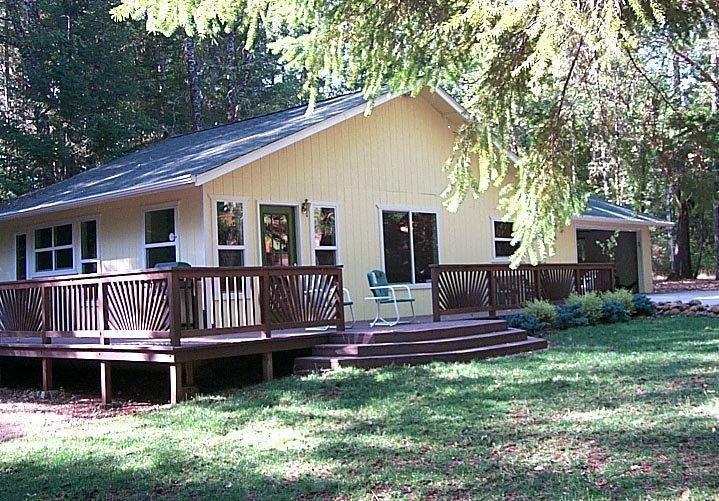 Talk about a diamond in the woods! This home was totally remodeled in 2004 with a new roof, added oversized - finished garage, deck around 2+ sides of the home, laminate floors, all new appliances, cabinets in kitchen, heat pump, attic fan, wood burning stove, 3 ceiling fans, new fixtures & cabinets in the bathroom, washer, dryer & water heater. There is lots of ways to expand this home and plenty of room to do it. There is a large list of personal items being sold with the home. Several outbuildings that includes an office, shop, storage with a guest bedroom above the shop. Well house has large concrete in ground holding tank. The well was drilled in 2005 & 4 hour flow test produced average of 4.6GPM. The property is level & private with lots of trees. Front yard is grass with sprinkler system installed. Now all it needs is a new owner. Oh, don't forget about the RV hook-up & dump station.