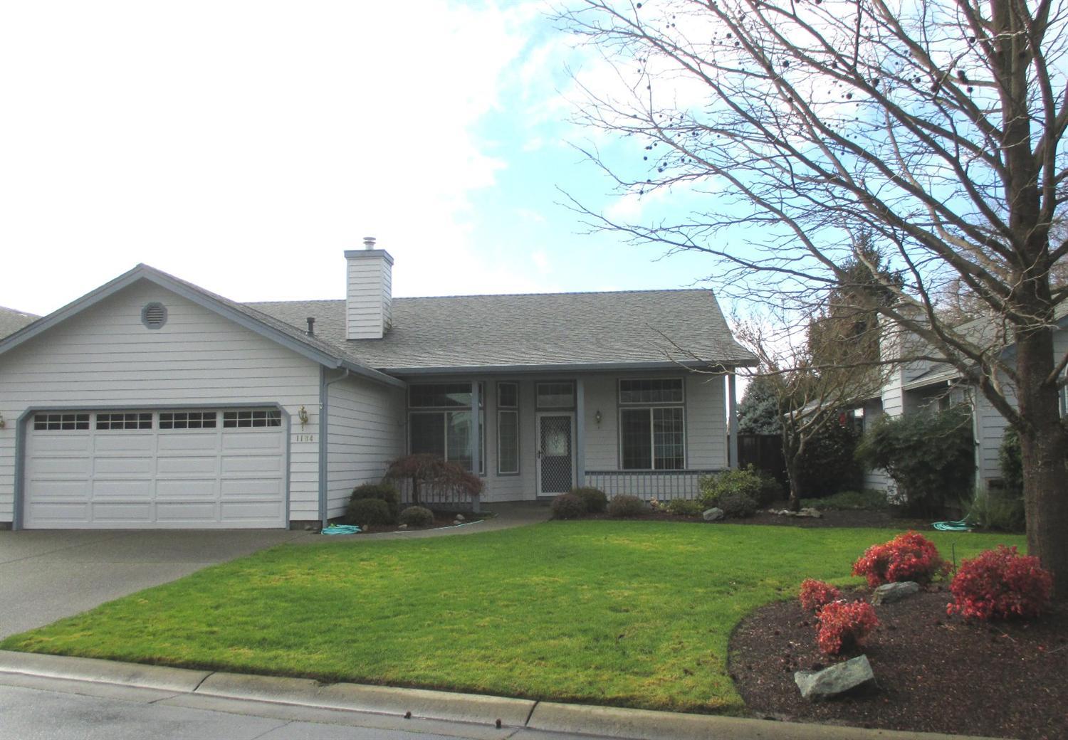 Enjoy the privacy and security of River's Edge, a gated, 55+ community, living in this beautiful 2 bedroom & den, which could be 3rd bedroom, 2 full baths, 1600 s/f jewel. Amenities include an open floor plan, gas fireplace and heat, spacious kitchen with tile counters, and an over-sized master suite with a large walk-in closet. Outside, a new roof, a 10x10 workshop with power and air conditioning, fully fenced backyard with patio, double car finished garage plus private access to the Rogue River and just a short distance to the Reinhart All Sports Park.
