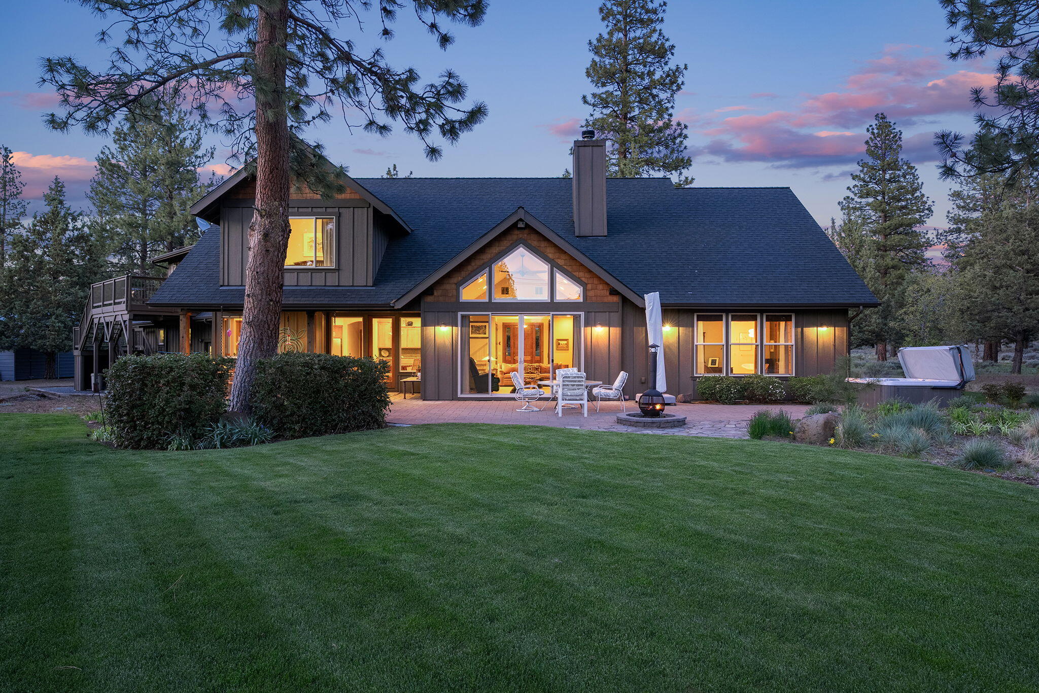Tucked away on 5 serene acres yet only minutes from downtown Sisters, this property delivers the rare blend of total privacy and in-town convenience. Gaze at Cascade mountain peaks from your custom cedar gazebo, stroll the landscaped yard, or plant your next harvest in the deer-fenced garden. The home offers four bedrooms— including a main-level primary suite with a freshly remodeled, spa-inspired bath—plus a private guest suite over the garage with its own entrance. Custom woodwork, updated fixtures, and generous windows bring warmth and light throughout. Car lovers and adventurers alike will appreciate the oversized three-car garage and a separate RV/boat garage tall enough for the big toys. From morning coffee under the pines to star-filled nights on the patio, every detail invites you to slow down, breathe deep, and enjoy the quiet luxury of country living—just a quick drive to shops, dining, and events in Sisters.