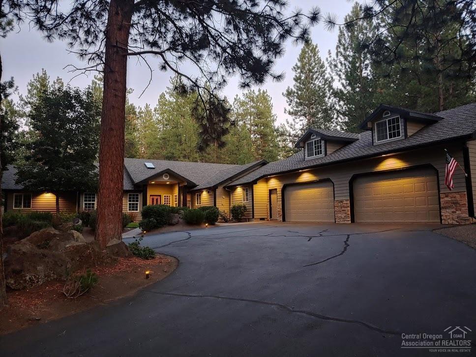 This charming home and neighborhood is the definition of mountain town living, all within 400 yards of the forest service trailhead for miles of walking & mtn biking!  Exceptional quality in this mostly single level NW style home surrounded by mature ponderosas for an amazingly serene setting.  This home was designed with today's modern needs in mind: huge gourmet kitchen, grand media/theatre room for Netflix binging in style, four bedrooms plus office OR office could be fifth bedroom, and separate primary suite in its own wing for privacy, plus huge bonus room above the garage for games or workout space.  Enormous 4 car garage with tons of storage.  New A/C.  50 year roof.  Recent addition of 220 volt RV/EV plug in on West side of garage.  Plenty of room for your RV.