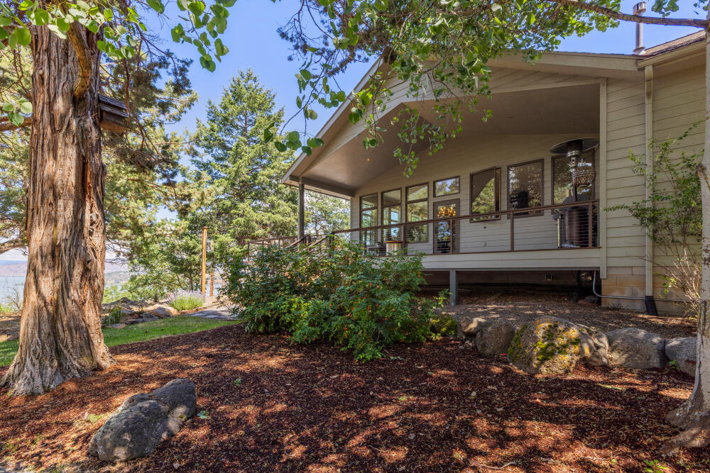PANORAMIC WATER VIEWS WELCOME YOU TO THIS MODERN SINGLE-LEVEL HOME AT THE RUNNING Y RESORT. The panorama includes Klamath Lake, Buck Island, Mt. Scott, and Crater Lake. A custom cable deck railing enhances the view. Quality defines the home, boasting Anderson Wood windows, solid black walnut wood flooring, natural stone gas fireplace, LED lighting throughout, plus a 19th century Italian chandelier for that special accent. Perfect for entertaining, the open floor plan includes a wrap deck, partially covered, to extend the seasons of your outdoor living. The stylish kitchen features granite surfaces, a large island, and a built-in wall feature for additional storage and an opportunity to personalize the space. The Best Laundry Room ever includes space for everything plus the laundry! The vaulted primary suite with office/sitting area offers lake views and a wood-burning fireplace. An oversized 3-car garage boasts gas heat in one bay and additional storage closets.