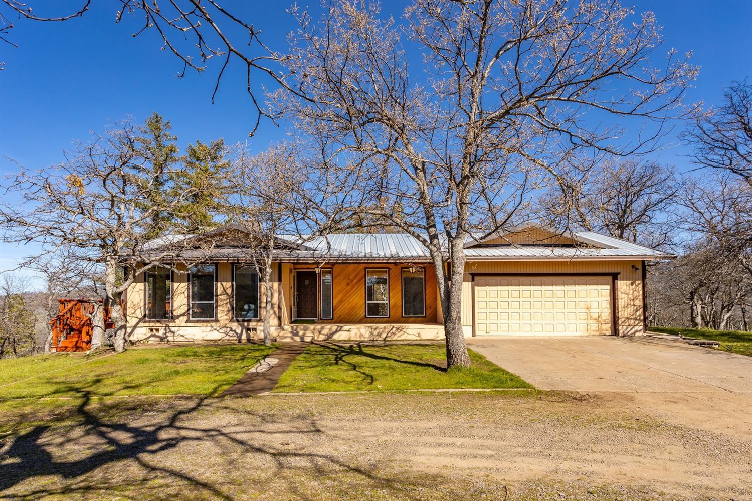 Enjoy breathtaking mountain views, looking down on the city of Ashland and Mt. Ashland in the distance from this private retreat! This 3 bed, 3 bath, 1652sqft home sits on over 12 acres with partial irrigation & RV parking with full hookups. The home welcomes you into an open living room with exposed hand cut wood beams, new carpet, wood stove, an abundance of natural light plus views of the city below! The spacious kitchen features an eat-in bar, plenty of cabinet space and a large pantry. The large Master Bedroom offers abundant closet space, full bath with a walk-in shower, additional storage and access to the covered back patio. The two additional bedrooms are roomy and offer ample closet space. The second living area features newer laminate flooring and access to the patio & 2 car garage. This home also offers a newer HVAC system and all new gutters! Come see this beautiful property today!