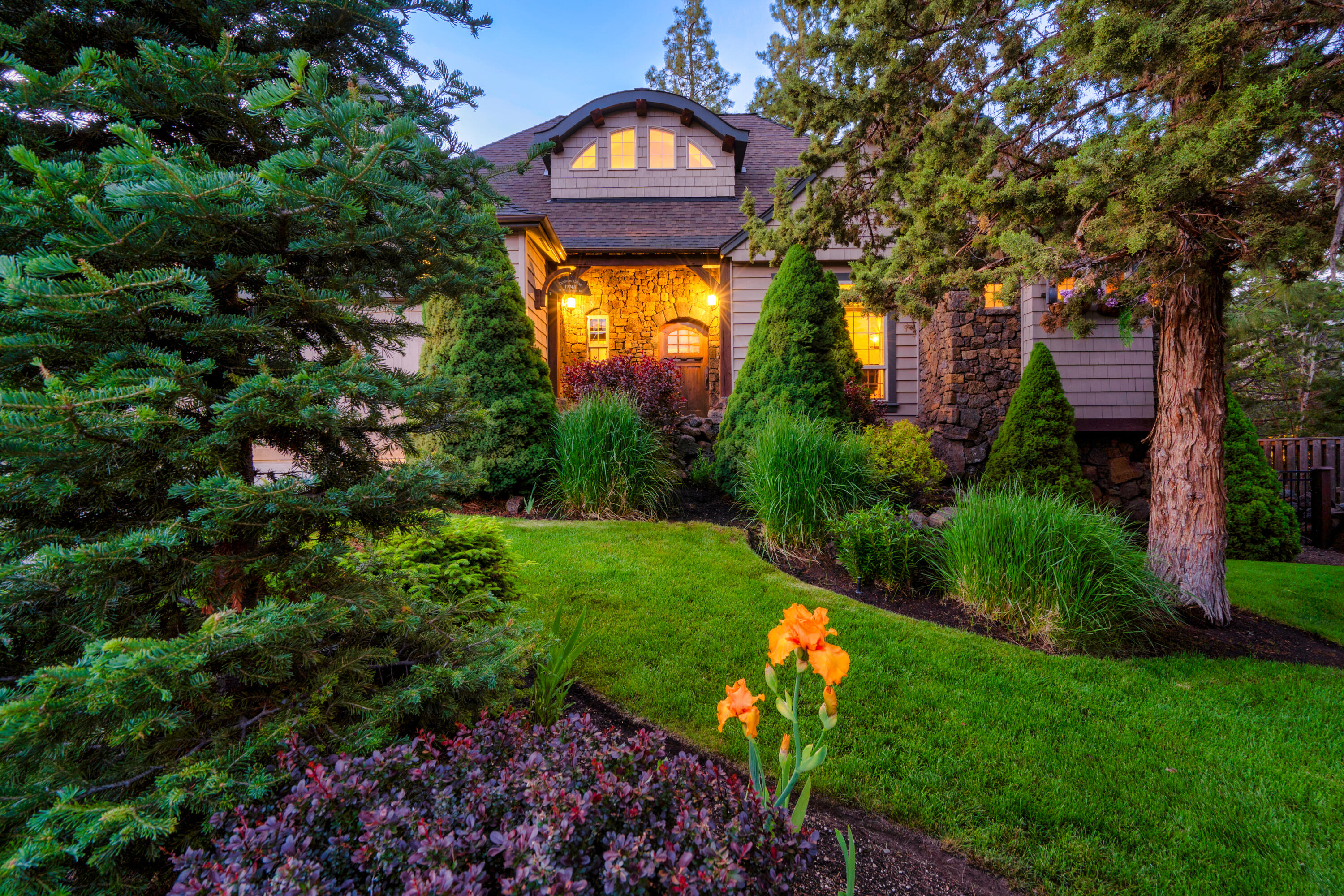 Stunning at every turn and a must see! Designed & built by Jess Alway, Oregon's premiere builder. This custom home boasts unrivaled quality & custom artistry...blacksmith forged iron work, distressed hardwood floors, travertine marble tile,  hand laid stonework, solid core custom doors, chiseled granite, & a copper lined barrel ceiling will surely wow the most discerning buyer. Vaulted ceilings w/multiple overhead timber-pegged trusses open to the great room & chef's kitchen. The main level primary suite exudes tranquility with a soaking tub,  separate large walk-in travertine shower & heated floors. Two additional bedrooms upstairs are ensuite, both provide plenty of privacy for guests. A separate flex space/daylight basement with outside access is an added bonus! This special home is a statement of artistry and conveniently located close to the river, Old Mill District & only .40 mile to the Deschutes River trailhead.