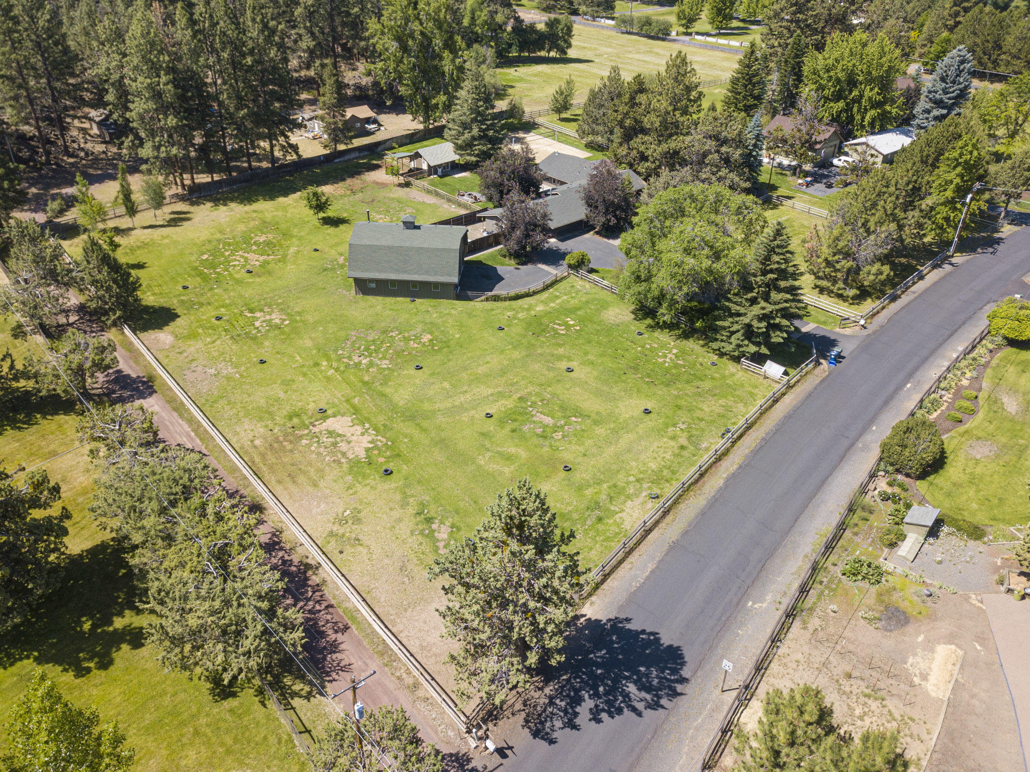 Quiet, private, country life close to town. This location cannot be beat! A stunning 2.1 acre property located just under a 4 mile drive to Downtown Bend, mere blocks from the 184 acre Riley Ranch Reserve, and approx.1 mile to Sawyer Park and the Deschutes River trail system connecting to the Downtown Bend area. This single level, beautifully styled home with character has you feeling like you're home the moment you drive up. Fantastic separation of living space: one wing includes the vaulted family room, large vaulted master suite, dining area and kitchen; the other wing of the home includes a warm, inviting living room with wood burning fireplace, jr suite, bedroom and den/possible 4th bedroom. There is an attached 3 car garage plus a detached 1440 square foot 3 bay shop with office area . The yard is completely landscaped and fenced with a beautiful deck, hot tub, fire pit, and artist studio that is plumbed for water and toilet. Two fenced pastures, 2 acres in ground irrigation.