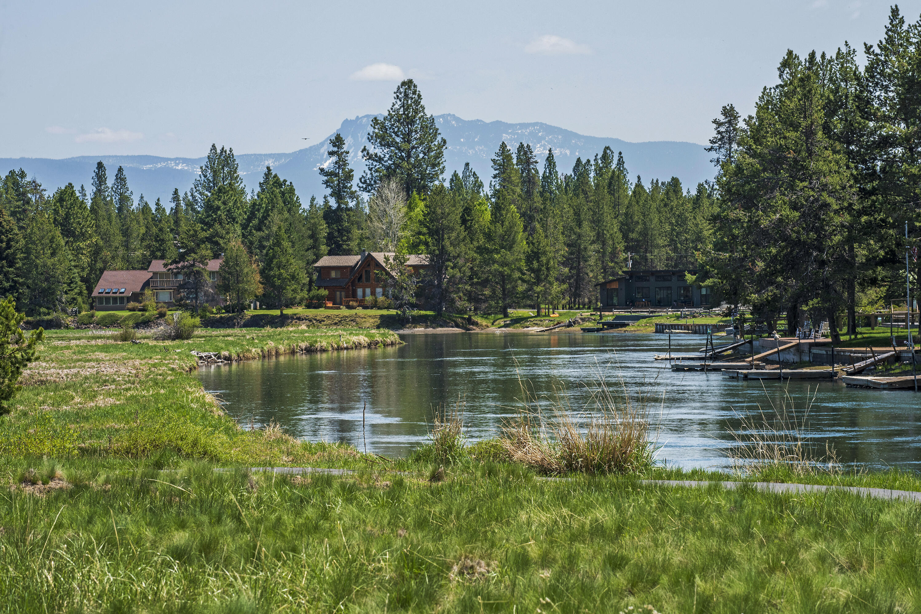 Escape to this stunning riverfront retreat in the sought-after River Meadows Estates, just south of Sunriver! Nestled along the banks of the Deschutes River, this spacious 5-bedroom, 3.5-bathroom home is the perfect getaway. With a huge bunk room, there's plenty of space for family and friends.
Enjoy the private hot tub, expansive outdoor living areas, and breathtaking river views. As part of the River Meadows Estates community, you'll have access to top-notch amenities, including a swimming pool, tennis courts, kids' play area, and a scenic asphalt bike path. Currently operating as a successful Short-Term Rental (STR), this property is a prime investment or personal retreat. With easy access to Mt. Bachelor and all that Central Oregon has to offer, your next adventure is always within reach. A true four-season paradise—don't miss out on this incredible opportunity!