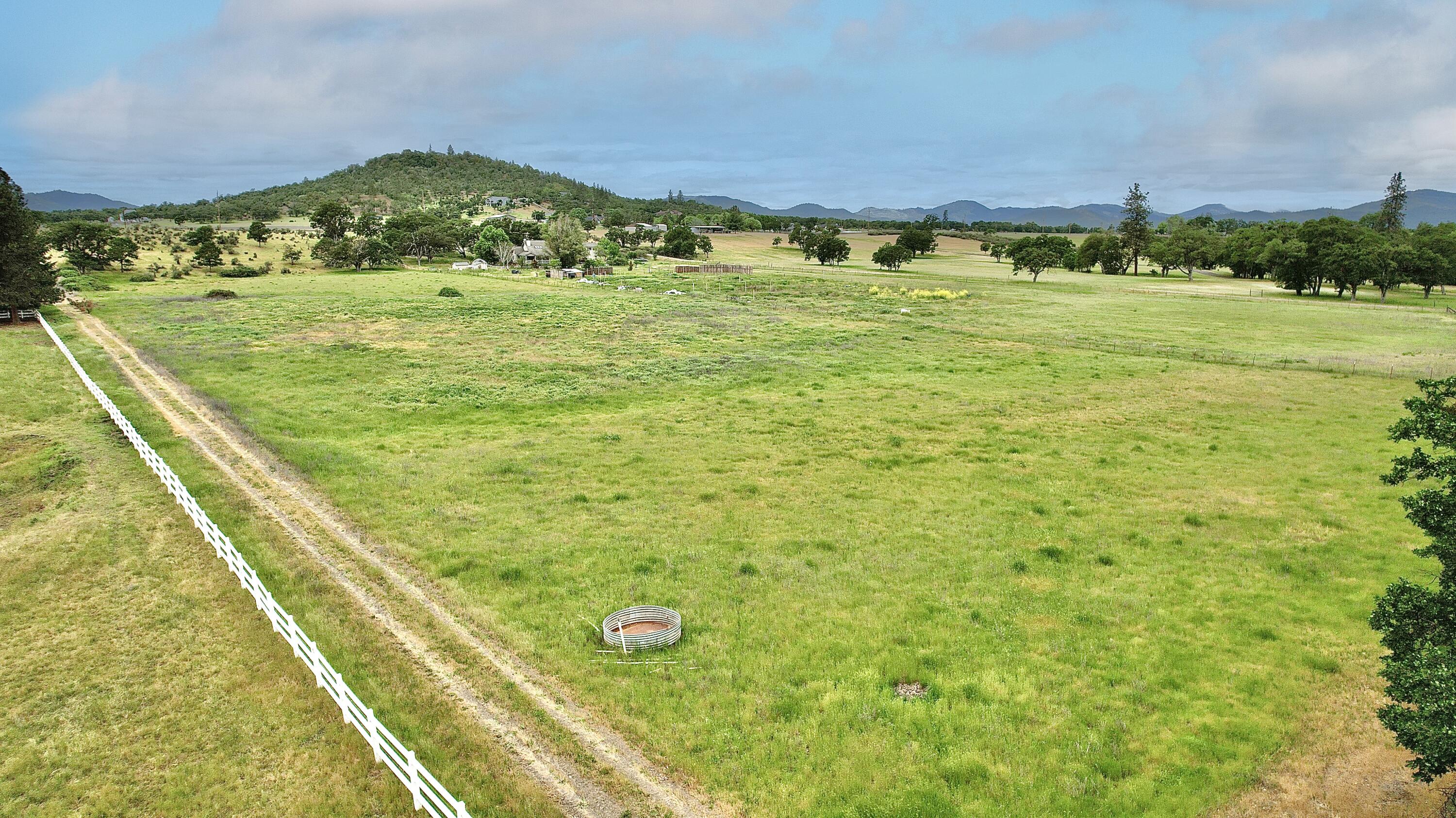 Prestigious 10.89-acre land on Modoc Road, well known for Horse Ranches, Farms, Vineyards and gorgeous properties that follow the Rogue River. Zoned EFU with irrigation rights from the Rogue River. Close to the Medford Airport. Gated and fenced for livestock and security. Bring your plans and purchase this beautiful property with amazing views. Enjoy fishing and rafting on the Rogue River, hiking Table Rock, boating at Lake of the Woods and Lost Creek Lake. The land is a flat, usable and lightly rolling property for hay or other crops that you may be interested in cultivating. There are no active wells or septic systems on this parcel. This land can also be purchased in conjunction with a connecting 10.02-acre Rogue River Front property with a year-round creek, a shop and a Mobile home with well, septic, power and roads (see listing for 12240 Modoc Road #A). Realtor must accompany all potential buyers for access. Buyer to perform due diligence for construction and uses of the property.