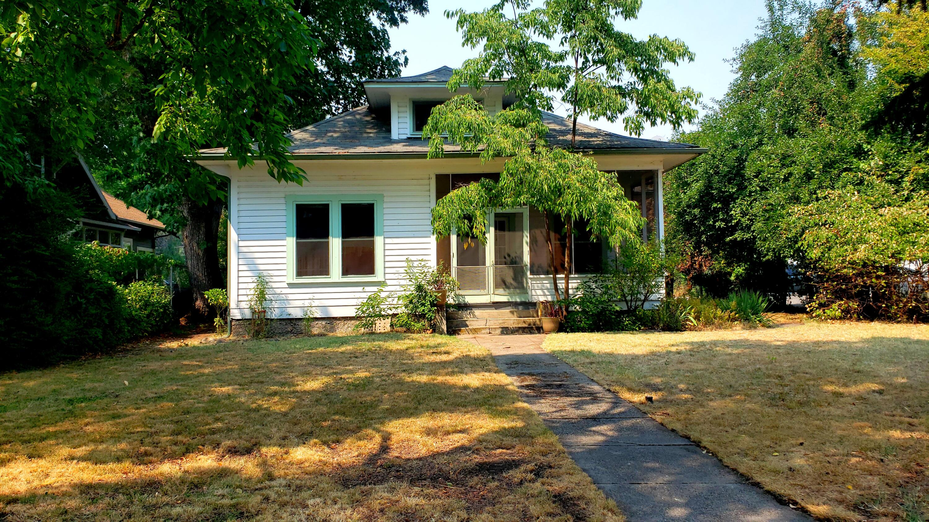 Historical charmer with many features only found in vintage homes! Built in 1905 this 2 br 1 ba home is on a .31 acre lot right in downtown Eagle Point.  Detached shop with loft. Potential to add ADU. Original oak hardwood floors, original trim and hardware, leaded glass windows and more. Basement for storage.  New insulation in the attic, gas furnace, updated electrical and plumbing.  Potential for commercial use or additional dwelling with the Historical District Zoning. Buyer to do diligence on approved uses.  Located across from the historical Butte Creek Flour Mill.  Property sold cash / as is.   Attention investors!  Potential to add an ADU!
