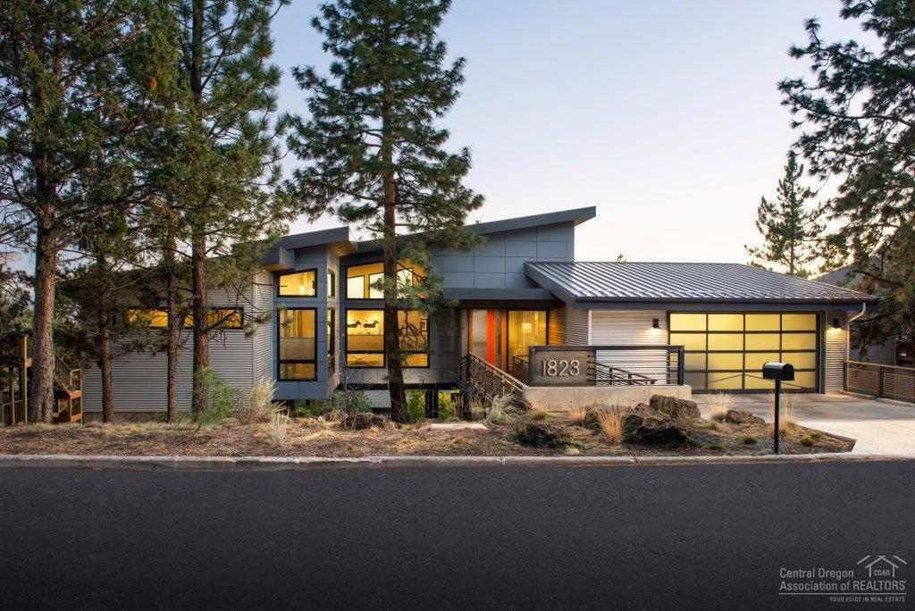 Custom built single level Industrial Modern home has 3 bedrooms, 2.5 baths, 2500 sq. ft. & features polished concrete floors w/in-floor radiant heat, vaulted 20 ft. ceilings, exposed steel beams, Chef's kitchen w/European cabinets, commercial grade stainless steel island w/solid black walnut eating bar. Full wall folding doors that open to the patio w/breathtaking City views. Spa-like master suite w/fireplace, walk-in Dbl shower & free-standing tub. Over-sized 2 car garage w/epoxy floors & heated driveway.