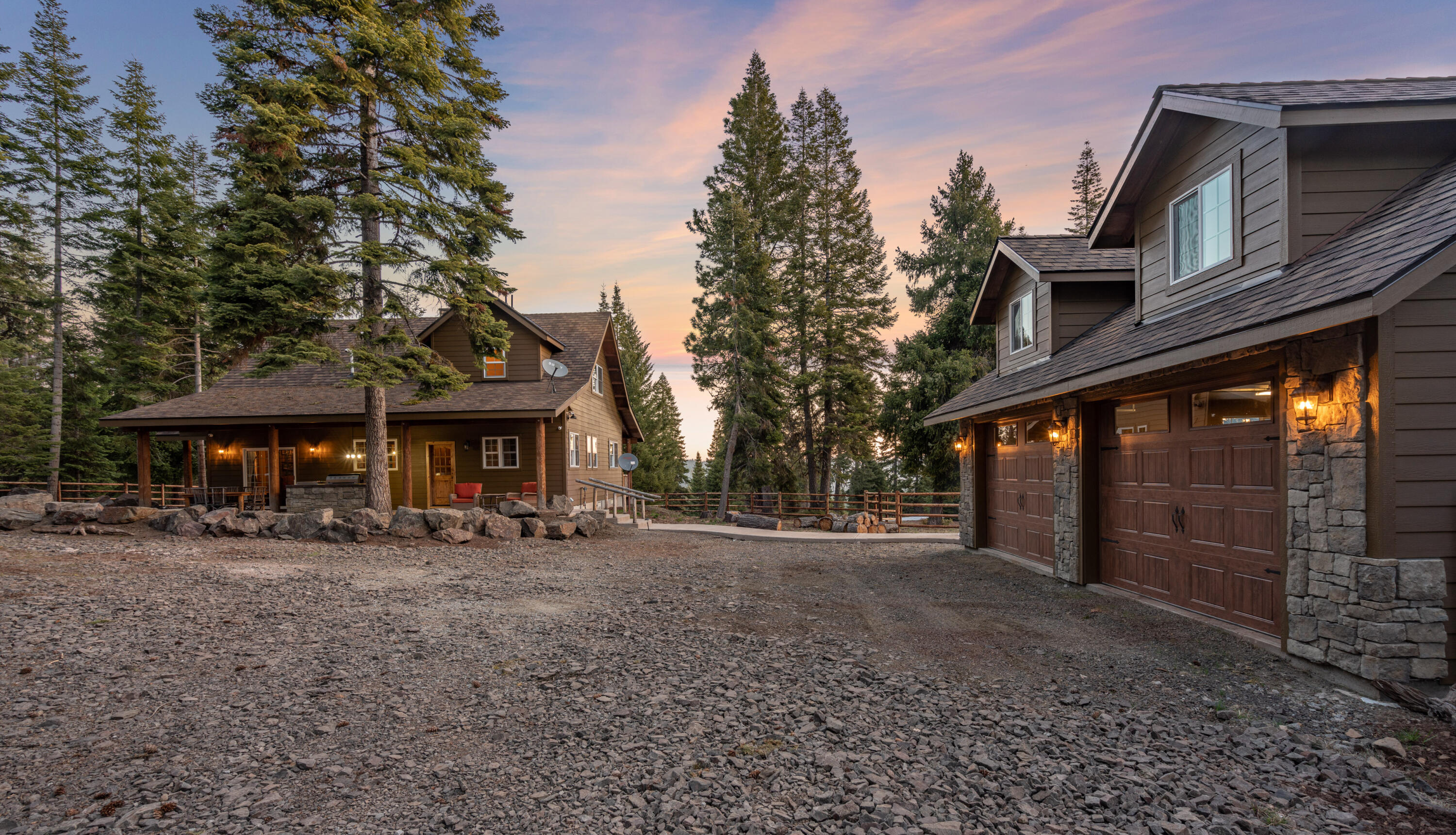 Nestled in the Cascade Mountains on 415 acres w/over 5,000 acres of adjoining public lands, this ranch offers unparalleled privacy & recreation. As you enter the property, you are greeted by a gated entry & towering mature evergreens. A private & tranquil setting provides the canvas for the craftsman-style home that enjoys a stunning view of Mount McLoughlin. As you enter the home you are greeted by grand vaulted ceilings, wood fireplace with floor to ceiling stone work, & ample windows that accentuate the mountain setting. The open concept floor plan has 2 master suites & ample upgrades throughout. Outside, you will find extensive outdoor entertaining with covered patios, gas fire pit, & built-in outdoor BBQ. The home has a modern off-grid system with both solar panels & a generator supplying power to a battery bank. Plus a detached garage & shop! Approved second homesite. Miles of roads & trails within the property.
