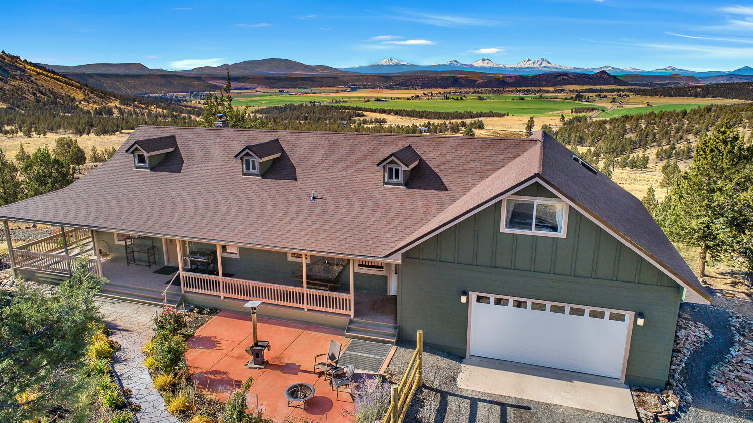Peaceful Setting & Cascade Mountain views serve as the backdrop for this 2468 SF Custom Home on 162 ac. Lots of updates that kept comfort, style and efficiency top of mind. A newer woodstove, heat pump water heater & recent solar system make this a very energy efficient home. Hardwood, stone tops & an island cooktop. If you are seeking privacy & serenity, & being self-sufficient appeals to you, then the rolling hills, the springs that attract wildlife, the greenhouses & a large garden with water from a separate well will help you find what you are looking for. For hunting there are options to choose from. LOP tags if available or apply for private unit tags. Hike, horseback or ATV the land here is easy to experience. Wind among the trees past rock outcroppings & around springs to end up on a hilltop with views of mountains & sunsets that invite you to stay after dark to experience untold numbers of stars. There's also a large heated & insulated shop & covered RV parking w/hookup.