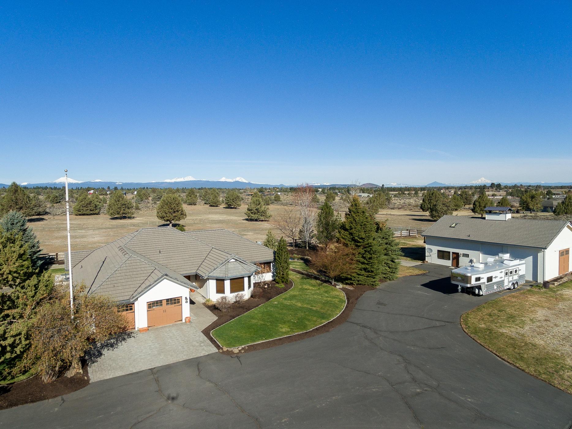 Price reduced!!!  One of a kind, this beautifully manicured 19 acre Equestrian Property has panoramic Cascade Mountain views, 6.5 acres of Arnold irrigation and a detached Carriage House/RV garage. Warm and inviting, the single level ranch home features a grand river rock fireplace, authentic barn wood flooring, new carpet and knotty alder door and moldings throughout. Recently updated kitchen (2019) is light and bright with white shaker cabinets, quarts counters and new appliances. Equestrian amenities include a 4- stall barn with paddocks and turnouts, wood paneled heated tack room, a 200 X 200 outdoor arena, fenced and cross fenced with high quality wood and no climb fencing, dry hay storage, equipment storage, 2 loafing sheds. The Carriage House Suite adds another 1,400 ft.* of finished living space with bathroom, office, common area, bonus room and fireplace. Huge 900* sq ft. heated attached shop with double RV bays.