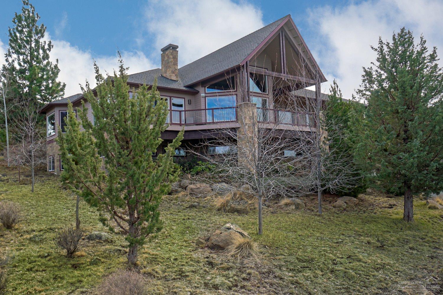 Located on one of the most desirable streets on Awbrey Butte, this unique home offers privacy, space and glorious views of the Cascades. 2 main level masters, bonus room, + office. Exquisite great room w/vaulted beam ceilings, perfect for entertaining. Spacious kitchen w/slab granite, informal dining & access to enclosed backyard. Secluded patio ideal for al fresco dining by outdoor fp. Daylight basement includes 3rd BR/ BA, & 3 shops. Garage allows room for 8 cars. Expansive deck overlooking the mountains.