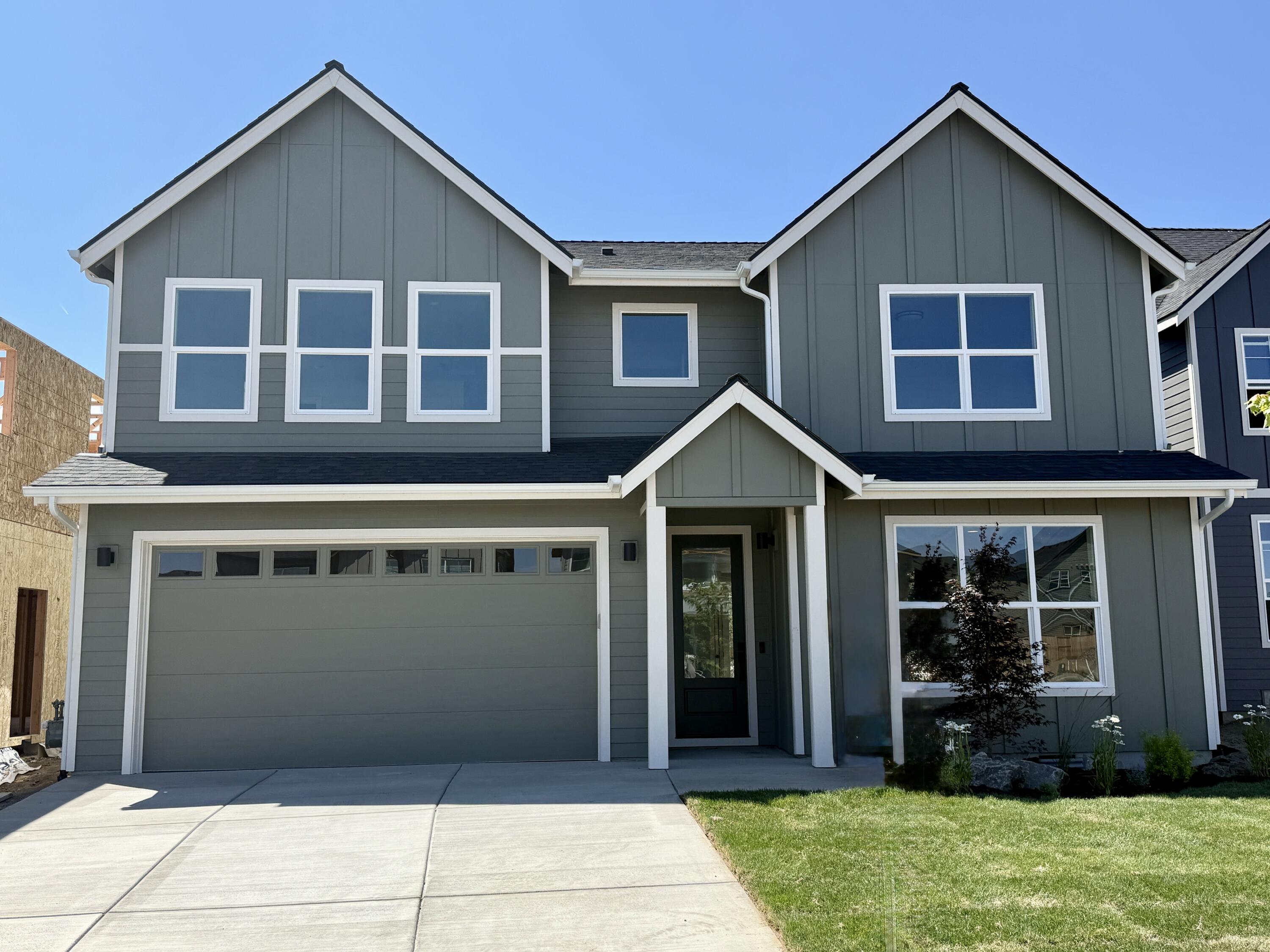 This main-level primary bedroom home features a full tile shower, a walk-in closet, and double vanities.  Built by Stone Bridge Homes NW, this property offers much more. The main level also features a two-car garage with a car charging outlet and an open-concept great room. The great room area features hardwood floors, stainless steel appliances, a walk-in pantry, quartz countertops, and a gas fireplace with floor-to-ceiling tile.  Four additional bedrooms, a bonus area, a laundry room, and a guest bath finish out the 2nd floor. The home also features A/C, fencing, and landscaped front and back yards, and is Earth Advantage certified. The buyer will receive a 2-10 Home Buyer's warranty. Stevens Ranch offers parks, trails, caves, nearby shopping, dining, and the new county library.