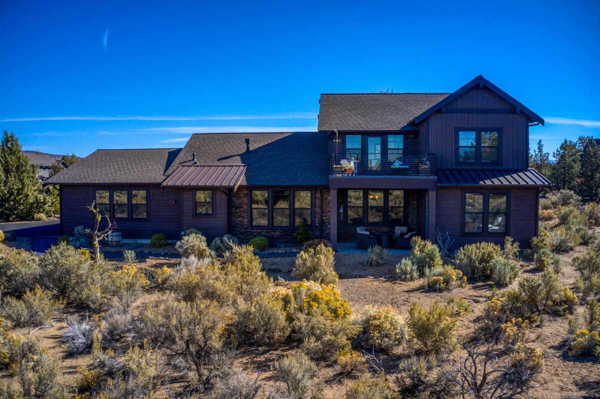 Beautiful two-level ranch style home situated on 1.39 acres with views of the Cascade Mountains and the Powell Buttes. This oversized lot allows for a shop or an ADU to be built in the future. This home is ideal for the entertainer-a large great room and dining room surround the stunning kitchen. The kitchen features stainless steel appliances and a newly remodeled designer butler pantry. Slab countertops and island are perfect for the home chef. Brand new gorgeous hardwood flooring throughout the living areas, a stone fireplace surrounded by built-ins in the great room. The master suite walks out to the patio offering a peaceful oasis with a very large walk-in closet, remodeled shower and oversized soaking tub. An office and remodeled utility room complete the first floor. On the second floor there are two additional bedrooms, large loft space and a deck to enjoy the views. The oversized 3-car garage allows for storage including the golf cart that is included with the sale of the home