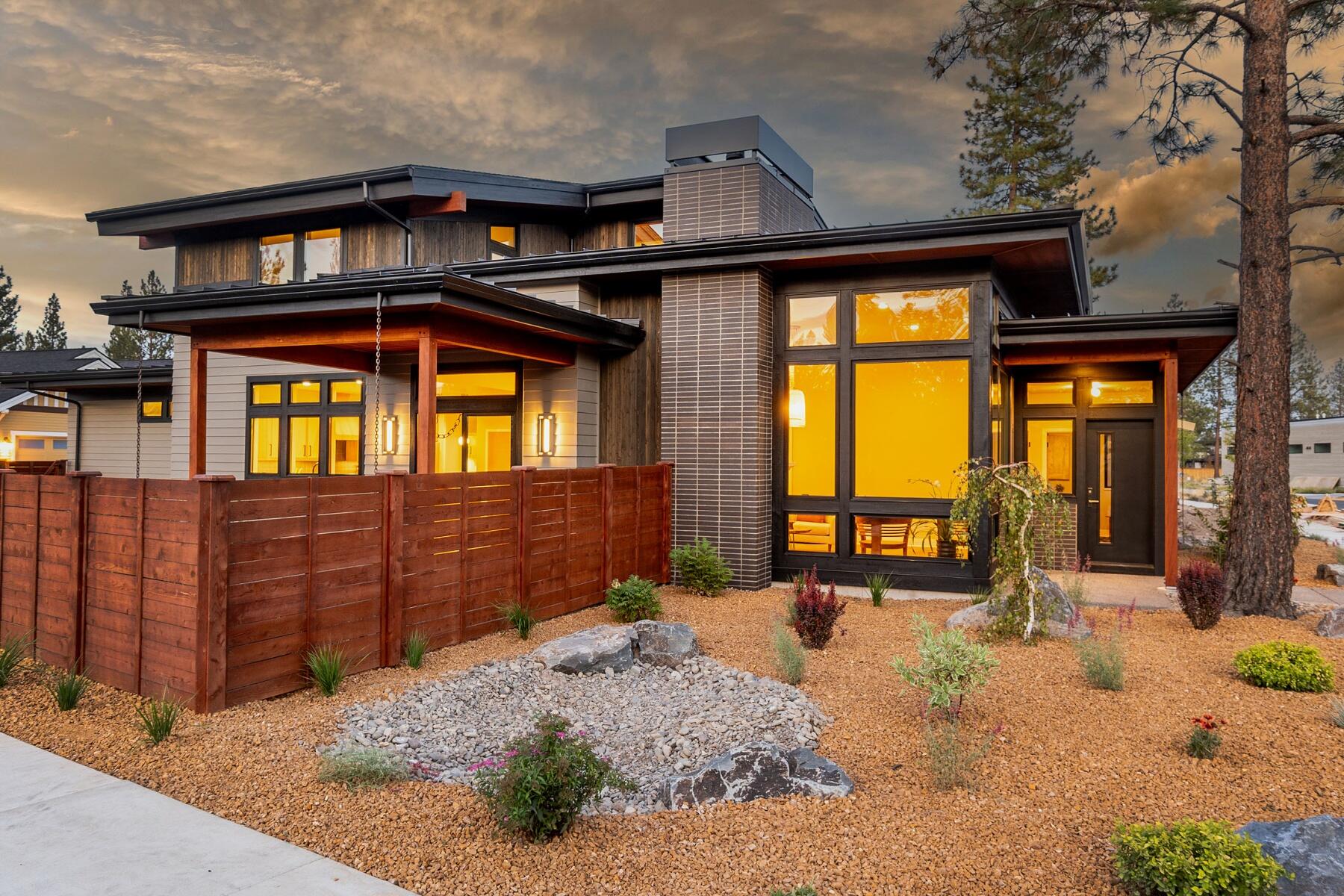Recently completed custom home in desirable Discovery West by award winning Leader Builders. Enjoy the open concept floor plan & kitchen featuring Quartzite natural stone counters, professional level appliances, rift sawn white oak flush inset cabinetry, & more. Thoughtfully placed south & west facing windows light up the 16' tall great room w/ gas fireplace & built-ins, as well as spacious dining area w/ slider access to large covered patio + fenced & landscaped yard. Main level primary suite w/ custom barn door accessing the ensuite bath includes a gorgeous tile shower w/ recessed lighted storage shelf & dual shower heads. The main level also includes a conveniently located den, powder bath w/ live edge counter, & laundry room w/ sink + folding table. Upstairs find two additional guest bedrooms, guest bath, & open flex space perfect for a variety of uses. With an abundance of luxurious features & quality construction, this contemporary masterpiece is an absolute must see in NW Bend!