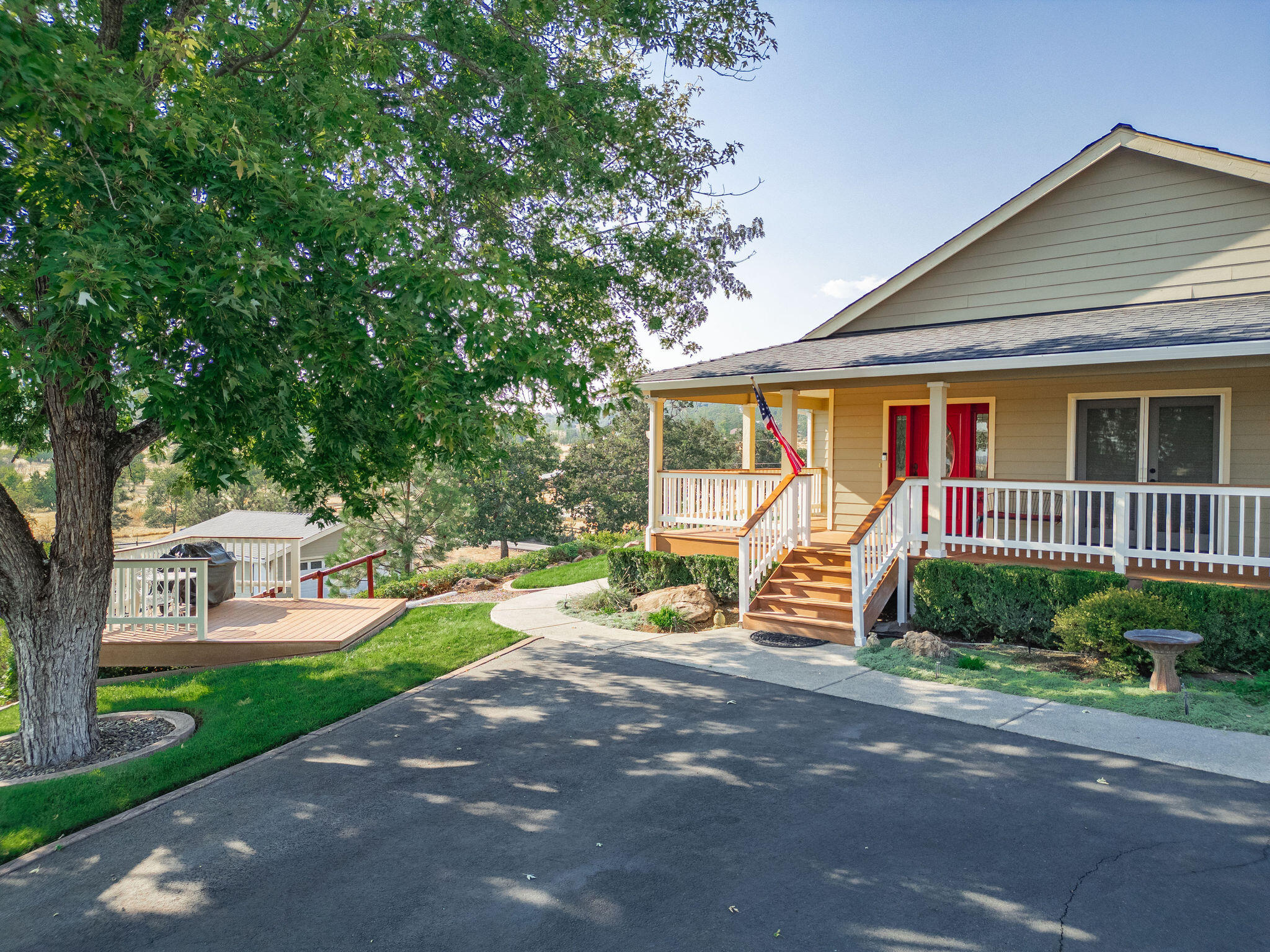 Stunning 2,242 SF custom home on 5 fully fenced acres with breathtaking panoramic mountain views! This 3BD/2.5BA beauty showcases vaulted ceilings, hardwood, tile & plush carpet throughout. The open kitchen features granite counters, stainless appliances, & plenty of storage. Extra pantry in the hall. The spacious primary suite offers a walk-in closet, double vanity, & a luxurious walk-in shower. French doors, granite counters throughout, & thoughtful design create comfort & elegance. Relax or entertain on the covered  deck or lower deck with views in every direction. A large fully fenced garden with she-shed (Has power & water close) adds charm & function. Property also includes an additional 2-car garage for storage. Fruit & nut trees on drip system,2  2,500-gal concrete holding tanks plus above-ground tank, & sprinklers to irrigate all 5 acres. Alarm on septic, wired for generator, & Starlink internet included—offering the perfect mix of modern convenience & country living!