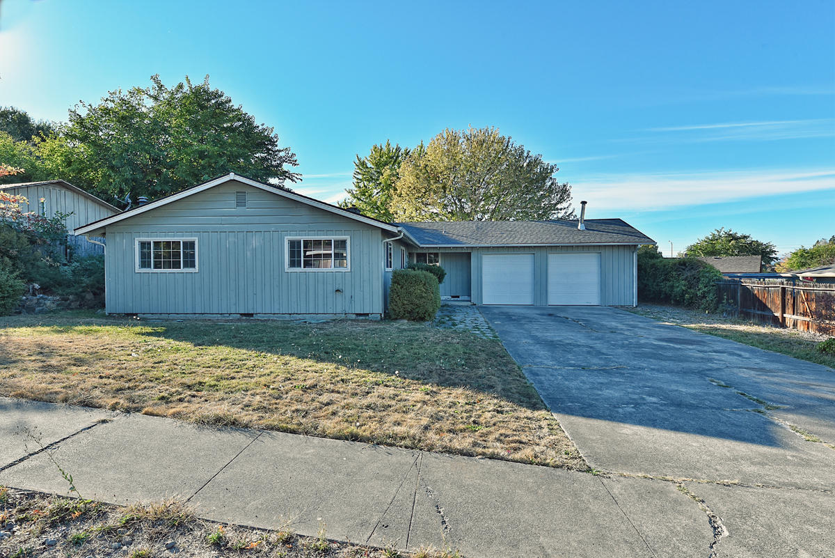 Come on in! This East Medford Classic has had just enough done to let you continue making it your own! As you enter, you'll find four bedrooms, two bathrooms, fresh interior paint, along with natural wood floors, lovely natural light, and a great open space waiting for you. Outside, through the French doors and past the covered patio, there's a lovely back yard area perfect for creating your own outdoor oasis. There's room for your toys too in the oversized driveway. The possibilities are endless here, don't pass this one up!