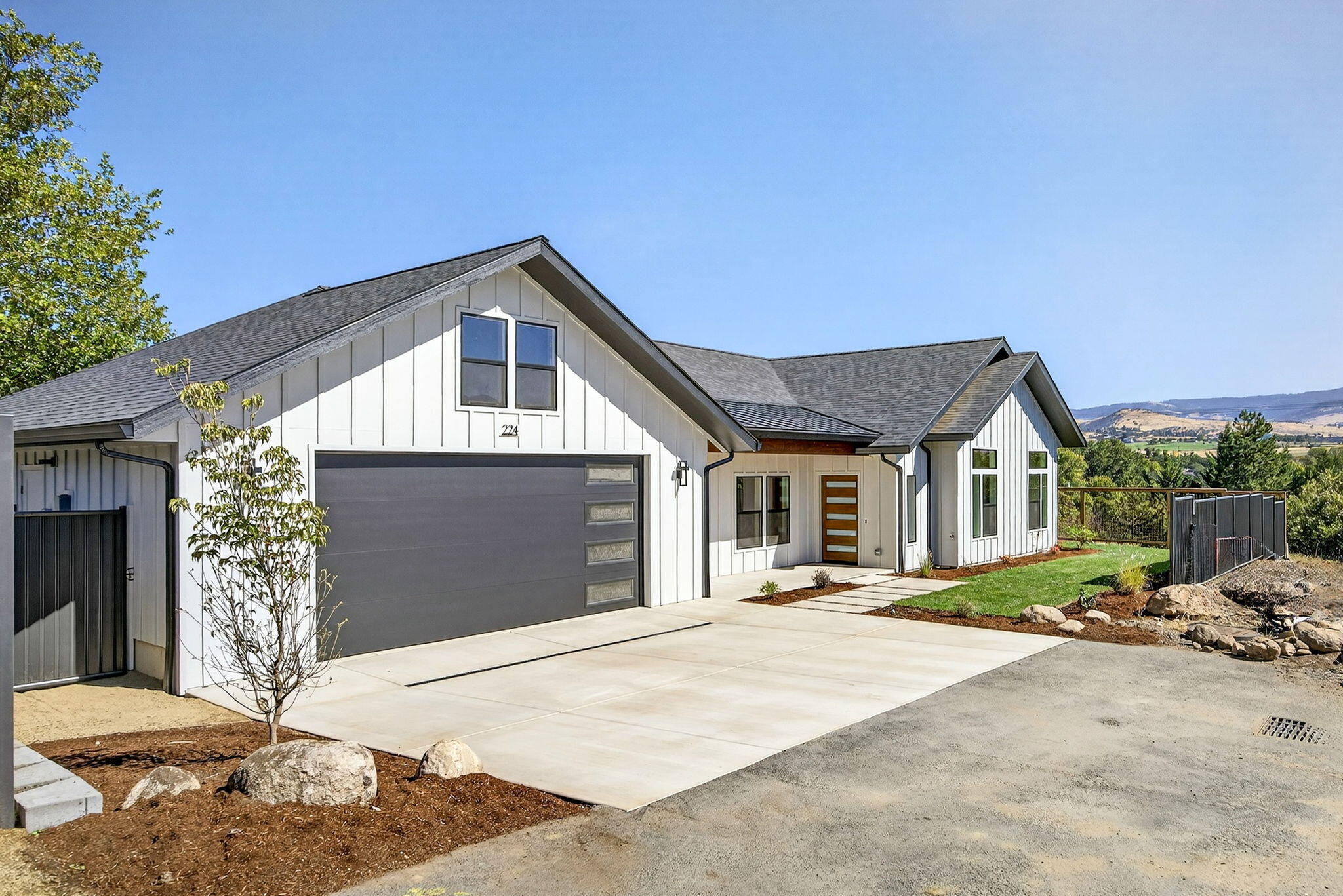 Welcome to Ash Meadows, a new 4 lot subdivision in Ashland Or. This rare find has two homes on one lot, each single level with lovely views of the E hills. The main home features 2019 sq feet, 3 bedroom and two and half baths, with easy access to Downtown Ashland. Its open design includes a spacious island kitchen with quartz countertops and backsplash and stunning great room design featuring a floor to ceiling fireplace and 9 foot ceilings throughout. The primary suite is a retreat with a spa-like bath, soaking tub, walk-in shower, dual vanity and skylight. A large slider extends living to a tongue and groove covered patio landscaped and fenced yard  The second home adds 1,188 sq ft with 2 bedrooms and 2 baths, remodeled with quartz counters, new cabinetry, and updated systems ideal for extended family, rental income, or guests offering a unique opportunity!