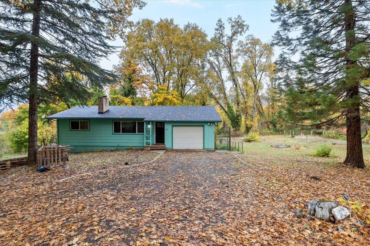 Beautiful home Located in Rogue River nestled in between Medford and Grants Pass, Oregon. This 1960 sqft home sits on 1.34 acres with Wards Creek frontage. Main level you have 2 bedrooms, 1 bathroom, living room with a wood burning fireplace, kitchen/dining with access to the New upper deck, perfect for summer BBQ's. Downstairs you have an additional 2 bedrooms, 1 bathroom, an large family room and a second wood burning fireplace.  New in 2025: roof, laminate floors upstairs and downstairs, kitchen counters, interior paint. Newer ductless heating and air, newer leach lines, new sub pump for well, and much more. This park-like setting has plenty of room for all your outdoor entertaining. Beautiful seasonal creek, mature Oak and Maple trees provide great summer shade, fruit trees include Apple, Plum, and Walnut. Rural living, near Salmon Fishing, White Water Rafting. See this one before its SOLD!!!