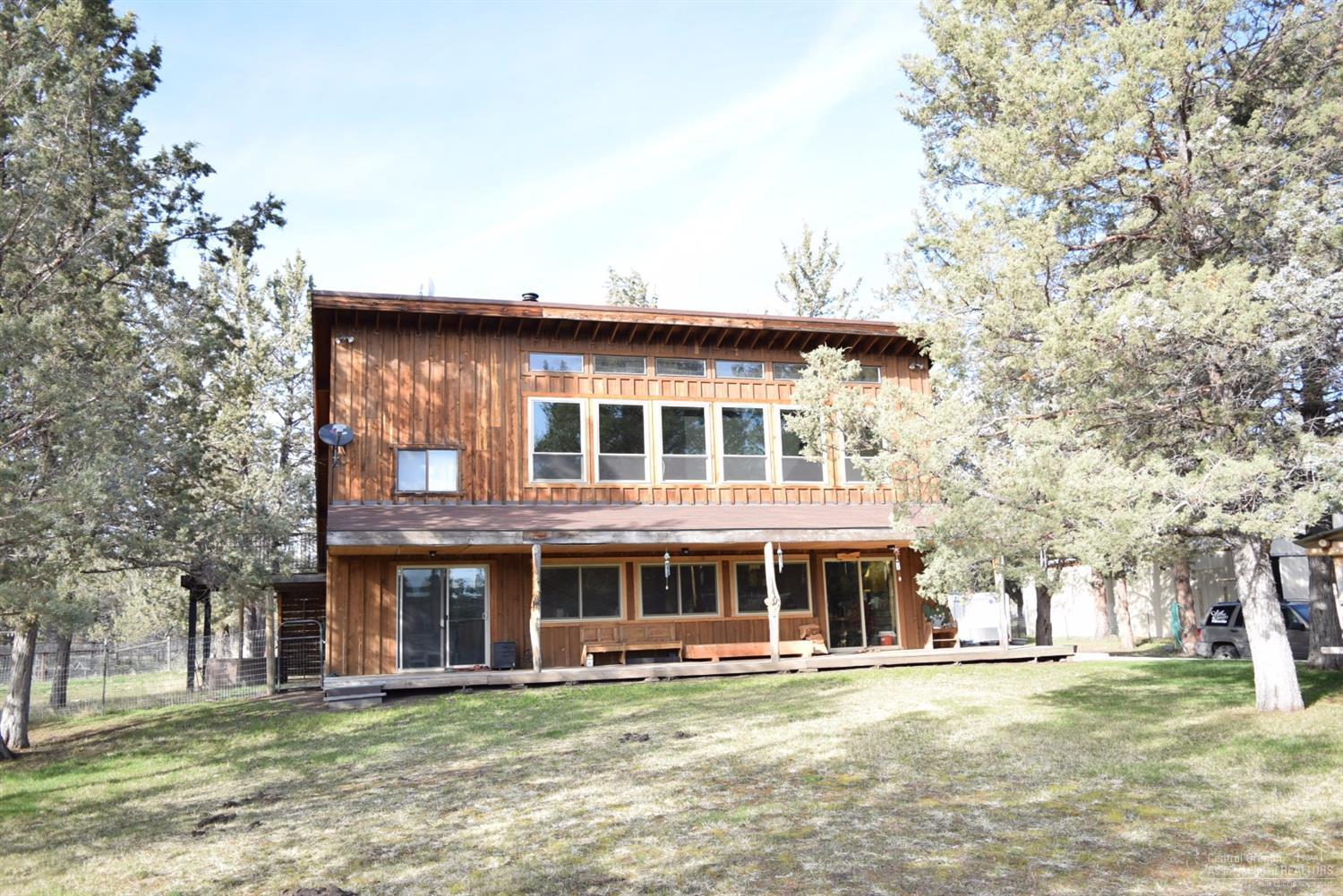 Unique Mini Farm Ranchette, 2.66 acres with 40x50 sq ft Barn/Shop and Arena. Country Western 1912 sq ft home welcomes you, vaulted ceilings, open floor plan, certified Blaze King wood stove, mega custom cabinets, 2 tiled kitchens (1 upstairs w/large family room and separate entrance,) attached garage. Barn has stalls, loft, tack room. Cross-fenced, horse washing station, covered feeding area, greenhouse, chicken house, pig pen, loafing shed, garden areas, full RV hook up + much more. Motivated Sellers.