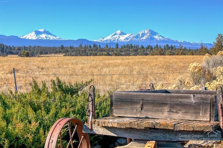 Grand NW Timber Home on 25 private acres w/amazing Cascade Mtn Views in Tumalo. Gorgeous timber beams in great room w/dining area all framing exquisite mountain views. Large slab granite kitchen & butler's pantry. Game room plus den & full bath on the main. Upstairs features loft plus 2 ensuites and large master w/bath. 15 Acres TID irrigation, paved drive w/3 car garage. Full shop approximately 42X48. Barn, hay storage, stalls, tack room, corrals, outdoor arena & storage building.Custom built, one owner.