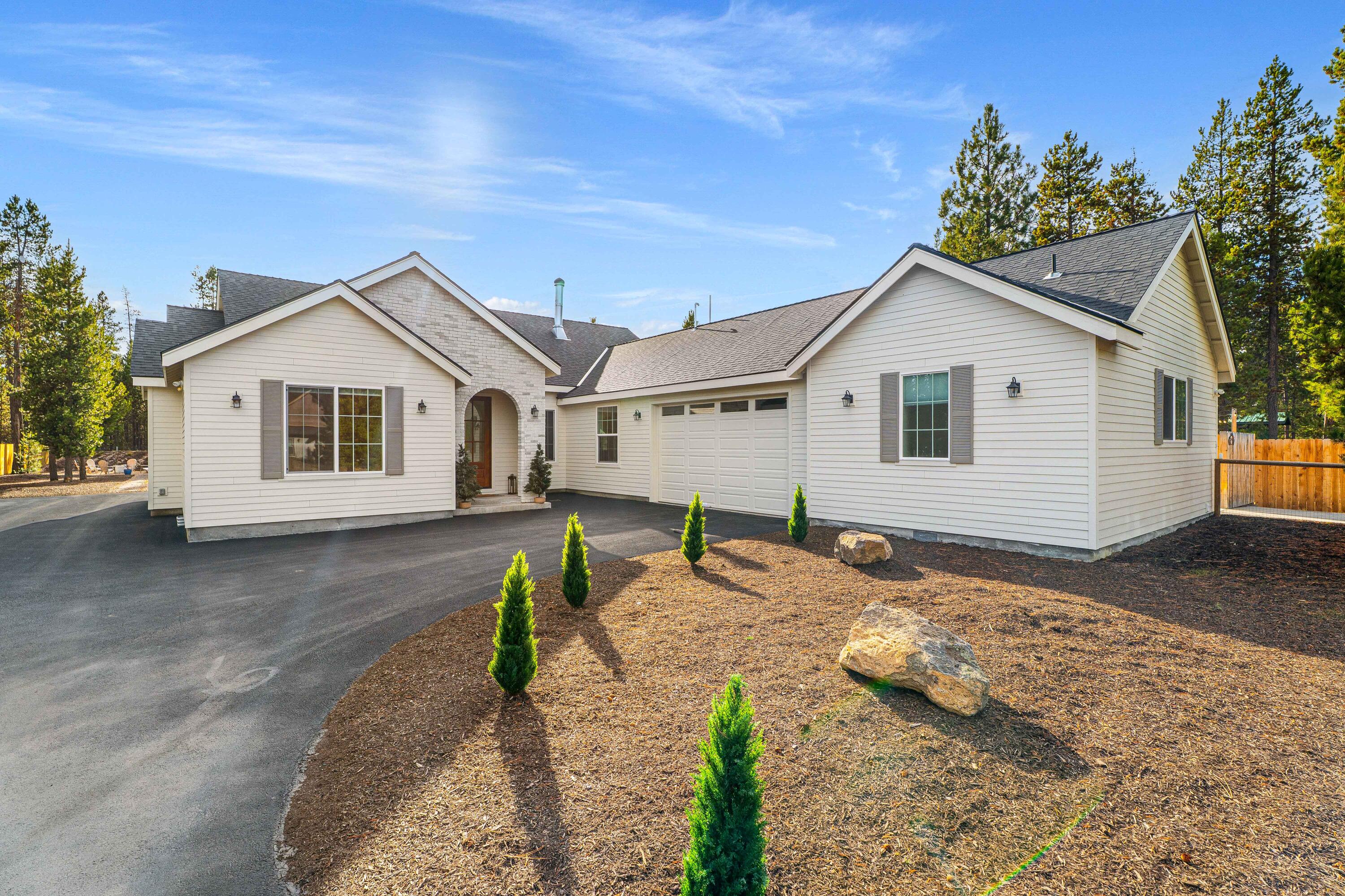 European-inspired single-level custom home on a fully fenced .55-acre lot surrounded by mature pines. Quality finishes throughout: white-oak hardwood floors, custom cabinetry, and true marble countertops. The European farmhouse kitchen features brass fixtures, open shelving, and professional-grade appliances. Light-filled great room opens to a large concrete patio, irrigated lawn, and private outdoor space. Built for long-term comfort with ice-shield roofing, Hardy siding, and a spacious two-car garage. Attached guest quarters include a private entrance, parking, laundry, and kitchenette (no oven) — ideal for multigenerational living, extended family stays, or rental flexibility. Minutes to Sunriver and Bend, this home blends craftsmanship, privacy, and low-maintenance.