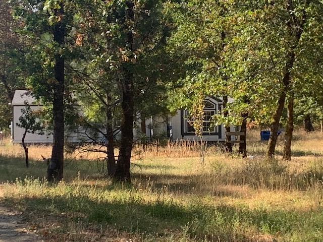 A 1994 manufactured home with 2 bedrooms and 2 baths double wide located on 6.39 acres offers lots of room for outdoor activities. The property is level, with beautiful trees and great views. There is a house standby generator, greenhouses, and storage container.