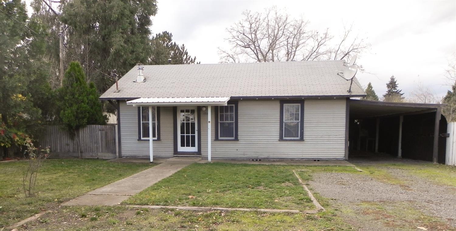 Great for 1st time homebuyer or investor. It has been a long time rental. Seller has cleaned it up and added new vinyl, carpeting, paint and some repairs. He's done. It is ready for the new owner and whatever touches they might want to add. Nice size living room with an accent wall. Kitchen has good working space with dishwasher & refrigerator included. The nice sized dining area adjacent to kitchen has wainscoting. Indoor utility room. The enclosed breezeway used to be a covered patio. It is not included in the square feet. The carport is long enough for two vehicles in tandem. The single car garage has been used as a shop but could house a compact car. There is an additional storage room with dirt floor at the back of the shop. All this on a .25 acre lot. Over the back fence is home to a couple of cows. Country setting but close to town. Griffin Creek school area.