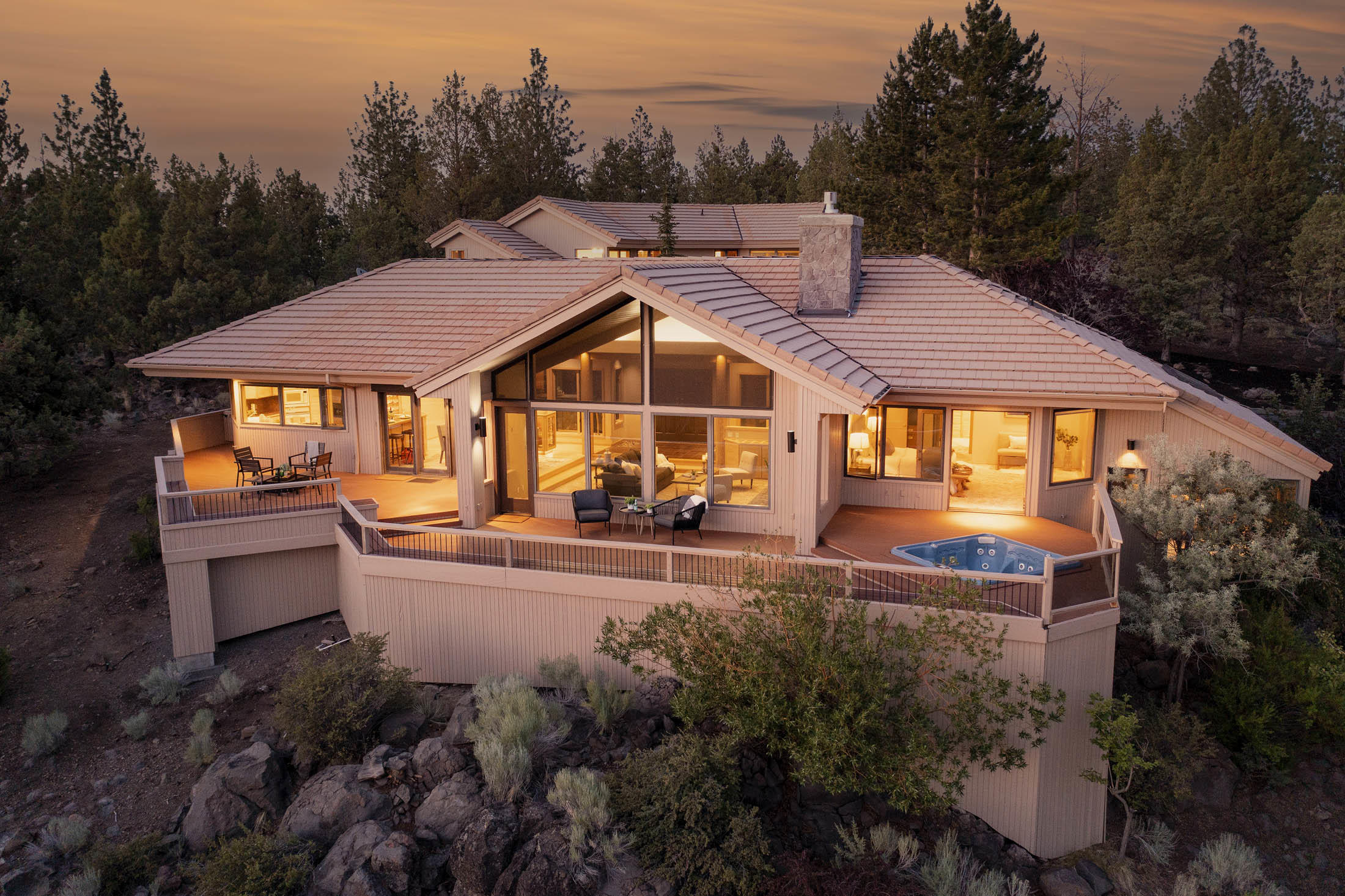 Panorama Lodge, the highest house on Awbrey Butte, has unobstructed Cascade and forest views in a private setting.   Architect Steve Van Sant's courtyard design brings guests through a waterfall-laced garden to a Great Room that frames Mt. Bachelor & the Three Sisters perfectly. The great room has a majestic gas rock fireplace and features pillars of sandblasted hemlock wood selected by the original owner, a timber trader. The Lodge's views are visible from the Great Room, Kitchen, 3 of the bedrooms, office, family room, & the large deck. The home has 3 master suites and a 4th bedroom.  Mostly single level living, plus a guest suite above the garage that has a family room w/wet bar and separate heating & AC.  Other features include an indoor recirculating lap swimming pool in a room adjacent to the master bedroom (currently unused). AC and ceiling fans.  The large 3 car garage has a workshop w/sink, heated storage room w/ski racks, fishing rod racks and hanging space for skiwear.
