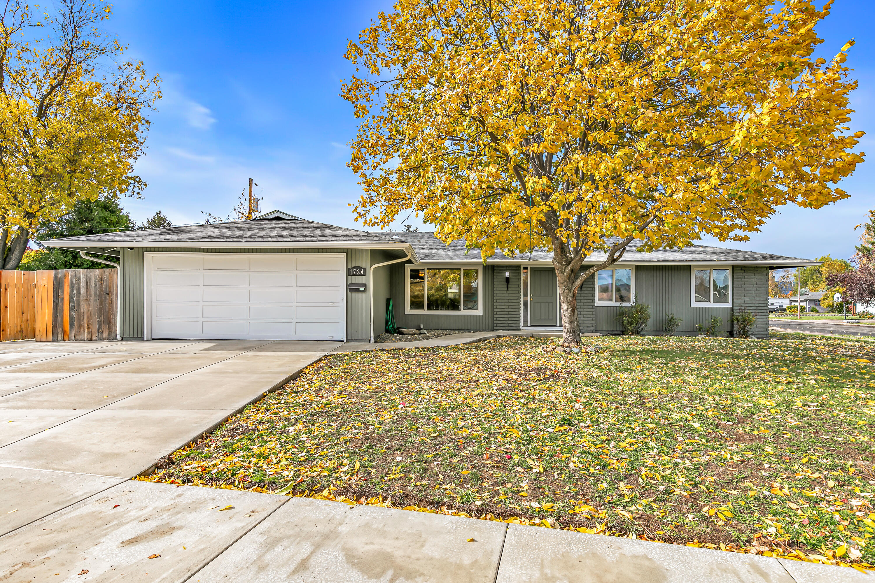 Situated on a quiet dead-end street, this fully updated home offers move-in-ready appeal. Recent upgrades include all-new interior and exterior paint, a brand-new roof, and fresh carpet throughout. The kitchen features granite countertops, while wood flooring flows through the main living areas, creating a warm and welcoming feel. Relax by the fireplace in the living room or enjoy the private backyard with fruit trees and the newly poured concrete patio. The driveway and sidewalks have also been redone with new concrete for a clean, finished look. Conveniently located near parks, schools, and a golf course, this home combines quiet neighborhood living with close proximity to South Medford amenities.