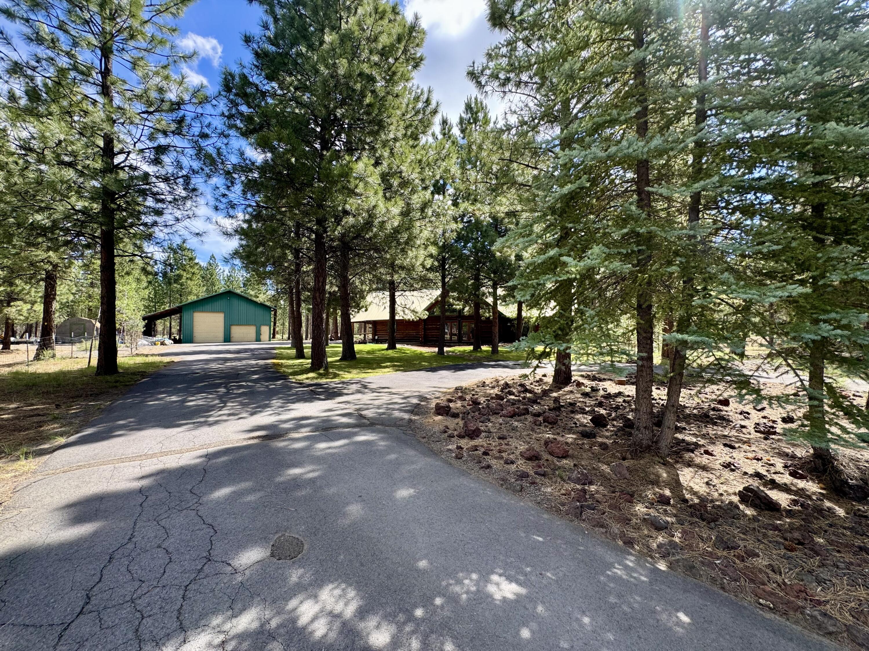 Back on the Market at no fault to property. Discover an exceptional 3-bedroom, 2-bath log home situated on 1.05 acres, backed up to over 12,000 acres of private land. With a generous living space of 3,314 sq ft, this home is designed for those who appreciate comfort and style. Spacious kitchen with plenty of cabinetry and tiled countertops. Cozy dining room for family meals.  Large living room with floor to ceiling windows and a certified wood stove. Open loft upstairs with a soaking tub and shower.  Large Living Room. A 30x36 shop/garage with a hobby room.  Convenient 30 amp RV hookup. Paved Driveway. 
This log home combines rustic charm making it an ideal getaway for nature lovers. Seller is offering $15,000 Credit towards Carpet/Deck Expenses. Don't miss out!