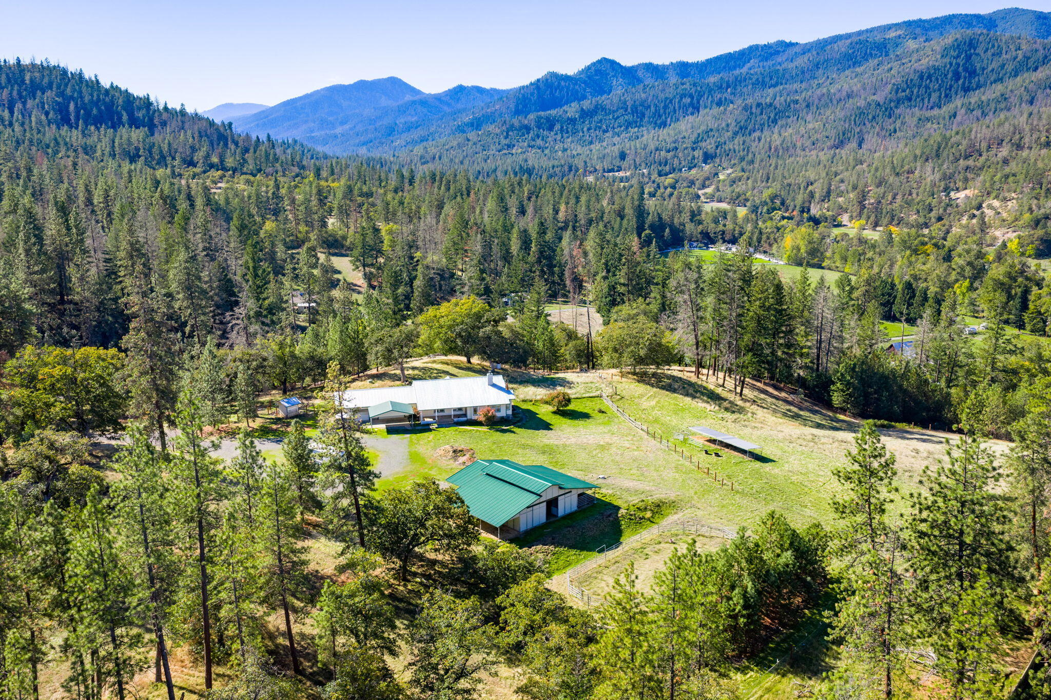Tucked away on East Side Road, this 12+ acre horse property offers privacy, beautiful mountain views, and room to roam. The charming 3 bed, 2 bath home features vaulted ceilings, an open kitchen, dining room, cozy wood-burning fireplace; the home is light and bright throughout. The primary suite has vaulted ceilings, a walk-in closet, and a large bath. Outside, there is a 1286 sq ft 4-stall barn with tack room and mostly fenced acreage make it ideal for horses, 4_H and/or hobbies. A spacious 3-car attached garage and RV parking ensure plenty of space for all your needs. Appointment only; please do not drive up  private driveway without representation. Thank you!