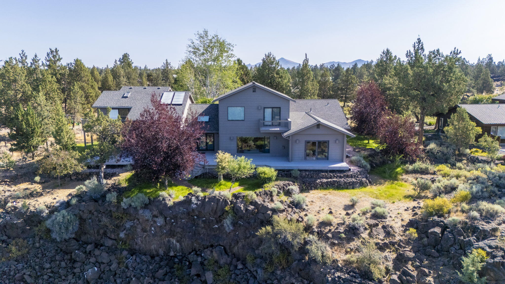 Tucked away on a picturesque 2.4-acre lot along the Deschutes River, this 4,030-square-foot home offers panoramic mountain and river views in a peaceful, natural setting. The property boasts two spacious primary suites, two additional guest rooms, and a versatile bonus room that can serve as an office or flex space, complete with a full bathroom—ideal for the remote professional or corporate executive seeking to work in comfort while taking in the spectacular scenery. Expansive decks provide the perfect vantage point for enjoying river views and local wildlife. The gourmet kitchen, featuring a butler's pantry (plumbed and wired for laundry), is designed for both style and functionality. The 3-car garage includes a workshop and a convenient half bath, perfect for hobbies or projects. This property offers the ultimate blend of luxury and nature, making it an exceptional retreat for those who value both beauty and convenience.