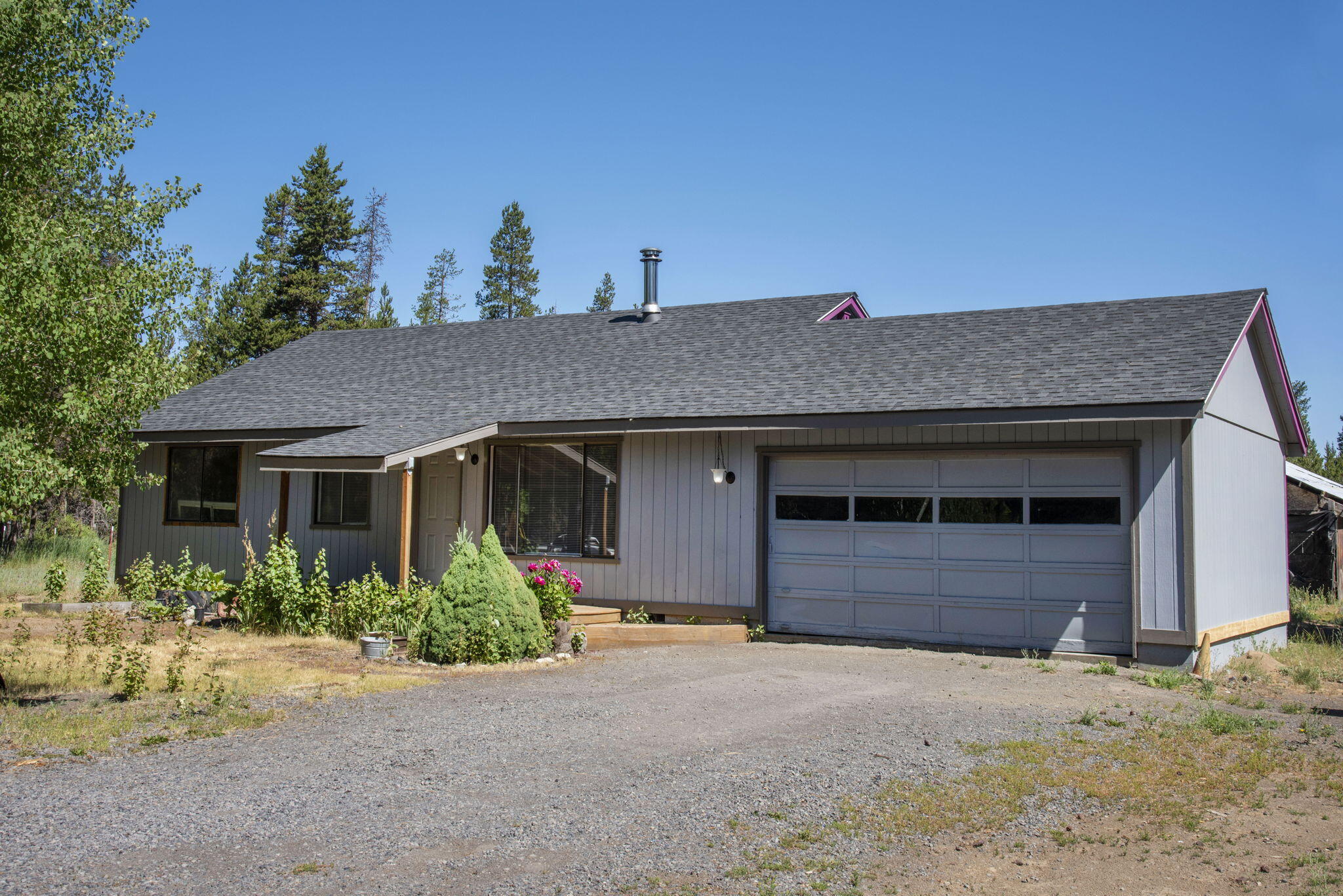 Don't miss this fantastic opportunity to own 3.19 acres in La Pine with a charming, single-level 3-bedroom ranch and a versatile barn complete with tack room, power, and water. Inside, enjoy stylish updates including striking accent walls in the living, dining, and bedroom, new flooring throughout, fresh paint, new stunning kitchen counters and more. Step outside to find a new deck off the dining room, dog run, chicken coops, woodshed, animal pens, cross fencing, and a greenhouse—perfect for extending your growing season. Major system updates include a new roof (approx. 8 years ago), ATT septic system (2022), and a heat pump (2021) for year-round comfort. This property blends country charm with modern updates and is ready for your animals, hobbies, and personal touch. Call today for more details or to schedule your private showing!