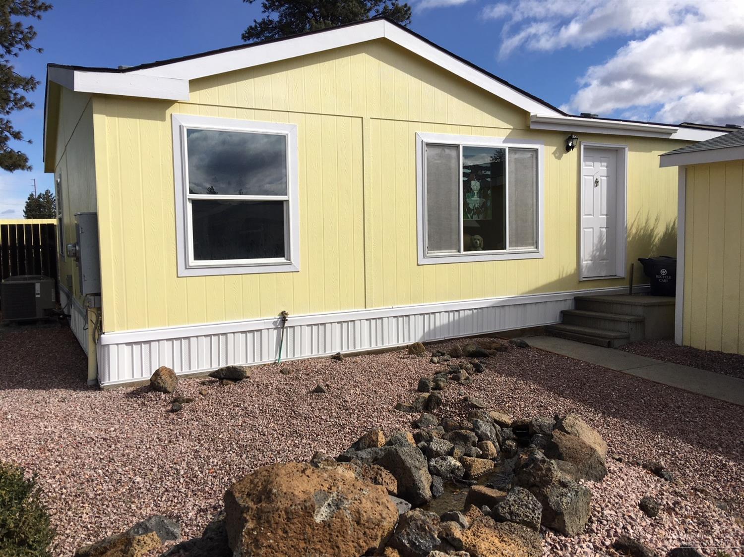 Motivated Seller. Make Offer. Lovely Snowbird, Vacation, Retirement or Starter Home. All New: Efficient A/C, Flooring in Kitchen, BA & LR. New Counter Tops, Glass-Top Stove, Micro, BA Sinks / Faucets / Toilets & Double SS Sink. Fenced Back Yard, Low Water Landscaping, Hot Tub, New Wrap-Around Deck, Water Fall, SS BBQ, Fire Pit Area, Dog Turf Area, Shed, 3D/2D HD Projector- 101 Inch Screen, JBL Surround Sound, $423/mo HOA for Clubhouse, Playground, Snow Removal, Land Lease & Land Taxes