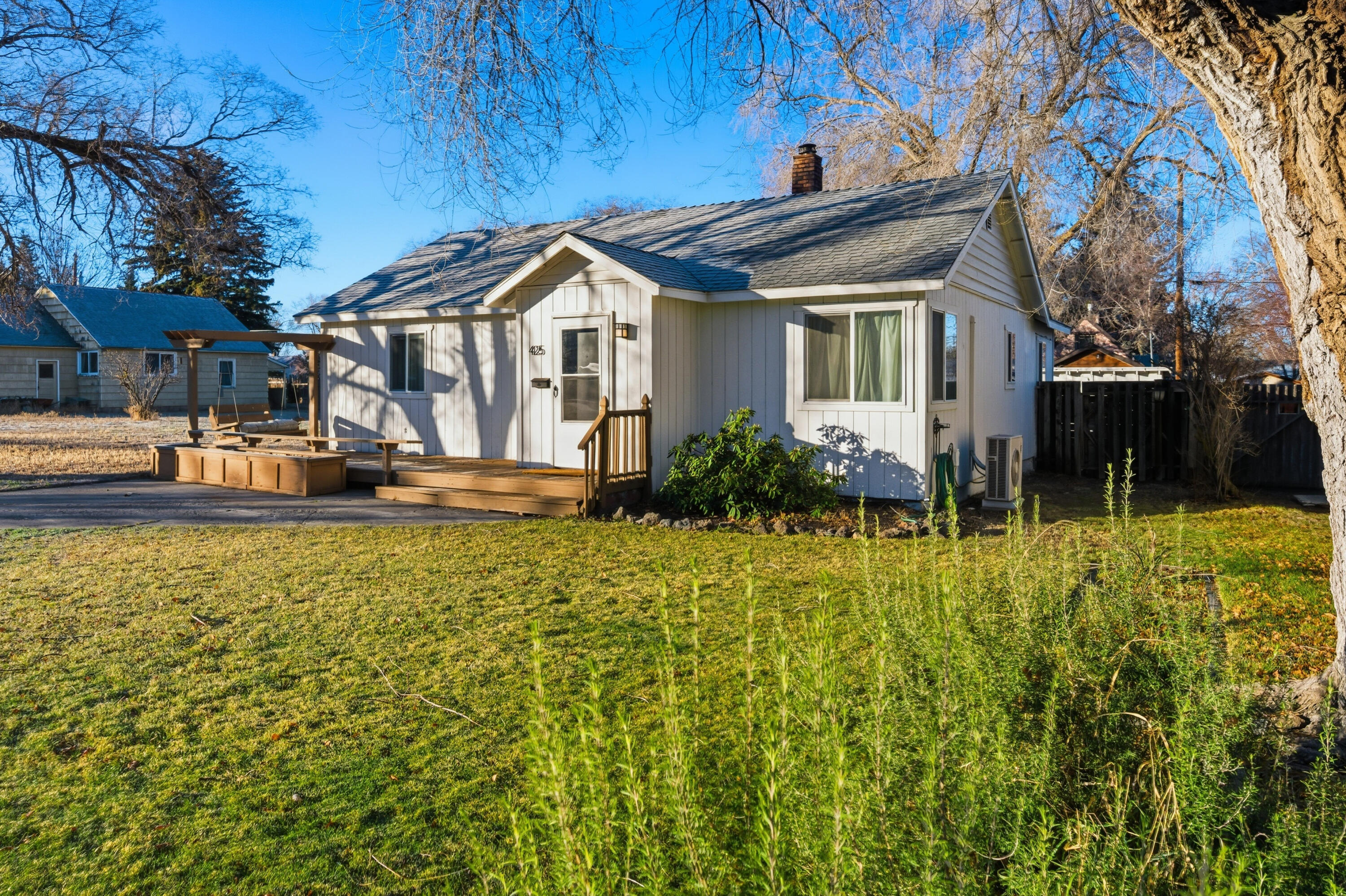 Highly upgraded & fully furnished downtown Redmond bungalow w/vintage charm, modern conveniences & a spacious floor plan. Upon entering the living area, the fir hardwoods lend to the warm/bright feel of the space w/room for two sofas & a chair. There's even a projector wall for movie night! The kitchen comes equipped w/all customary appliances, concrete counters, single bay concrete sink, pantry & tile floors. The adjacent breakfast nook/dining area leads to the back deck. Both bedrooms easily fit a king bed w/room for end tables. The shared bathroom blends modern & classic vibes w/a tiled shower complimenting a cast iron tub & concrete counter vanity w/raised sink. The washer/dryer are both in the bathroom & the floor is tiled. Outside there's a deck, built in Green Egg BBQ w/prep area, a paver patio w/furniture, fenced yard w/gated alley access for RV parking & yard access along w/a handy storage shed! The home also has a ductless heat pump system w/AC & a new electrical panel.
