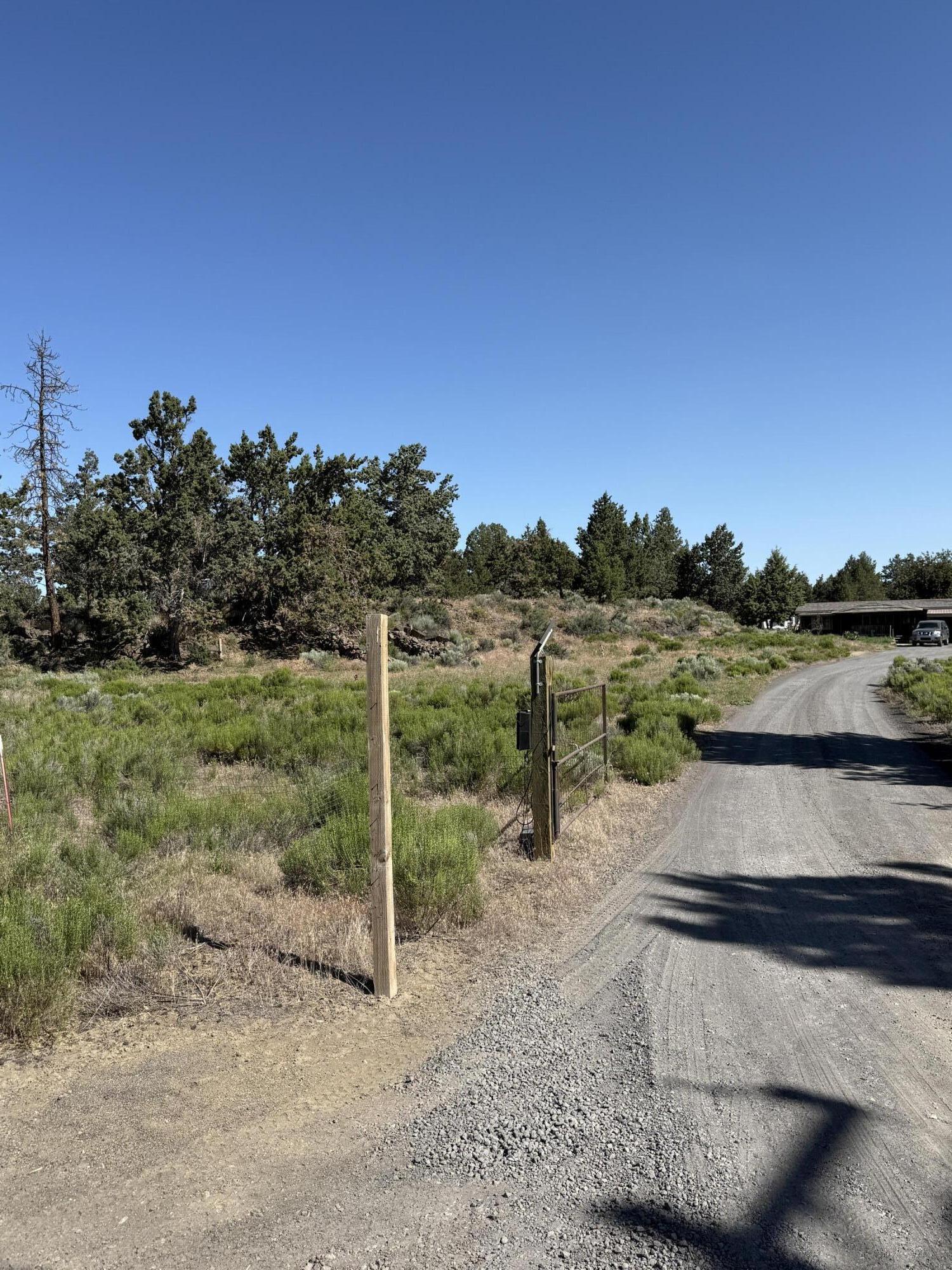This hard to find small acreage property is located in SE Bend near Caldera High School. This 3.4  acre homesite is mostly flat and has peek a boo Cascade Mountain View's from the top of a beautiful rock outcropping. The manufactured home features 4 bedrooms and 2 baths with a large semi enclosed garage and a huge enclosed storage in back. There is RV Parking including an RV Hookup and RV Dump station. There's plenty of room for all your toys.