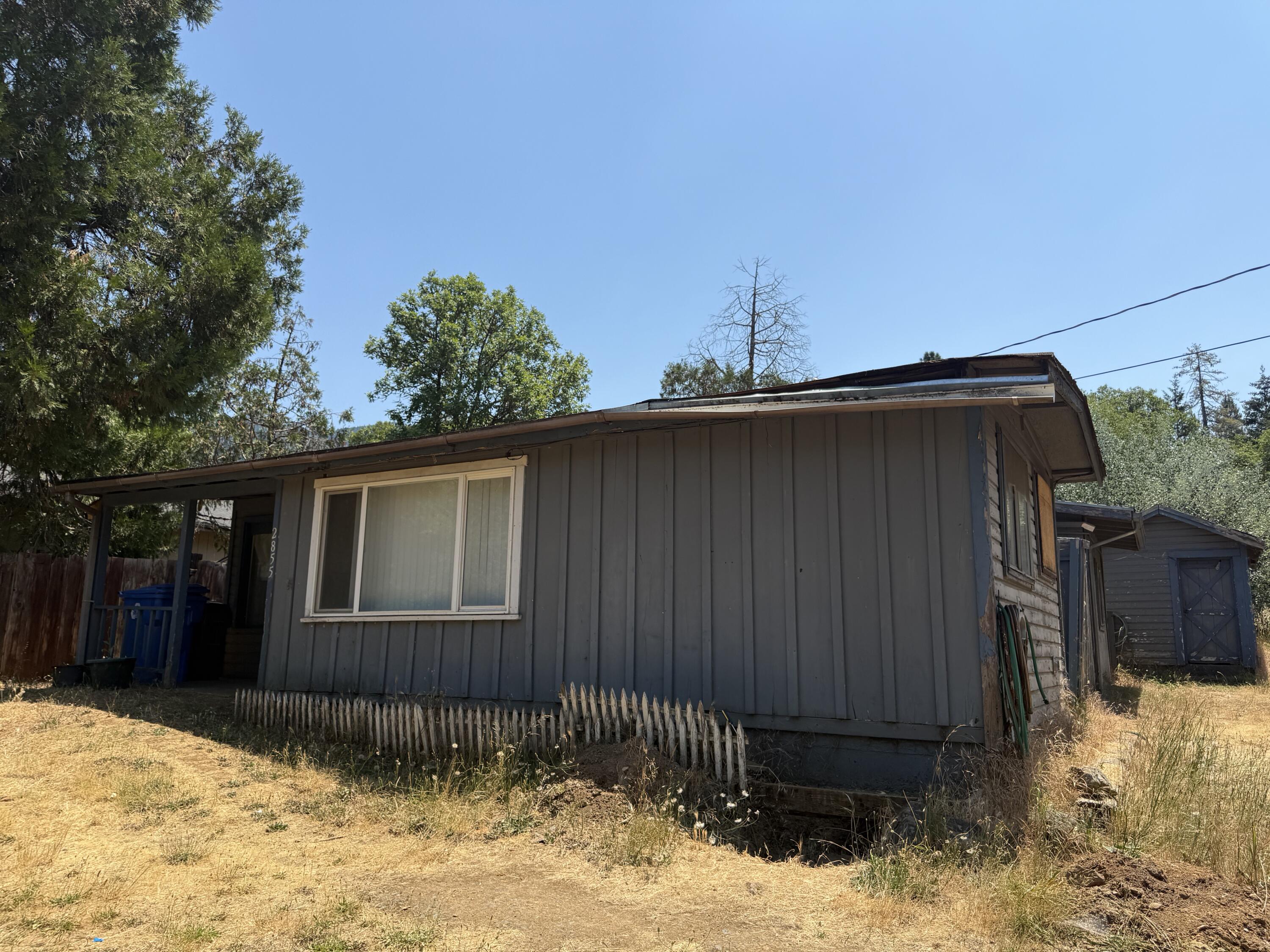 Investor Special! This 2 bedroom 1 bathroom home offers 967 square feet of potential on a fully fenced .34 acre lot. Whether you're an experienced investor or a buyer looking for a project, this fixer upper is full of opportunity. The generous lot provides room to expand, build an ADU, or create your dream outdoor space. Located 5 minutes from Rogue River access, shopping and entertainment. This property is ready for your vision so bring your tool belt this is the project you've been waiting for!