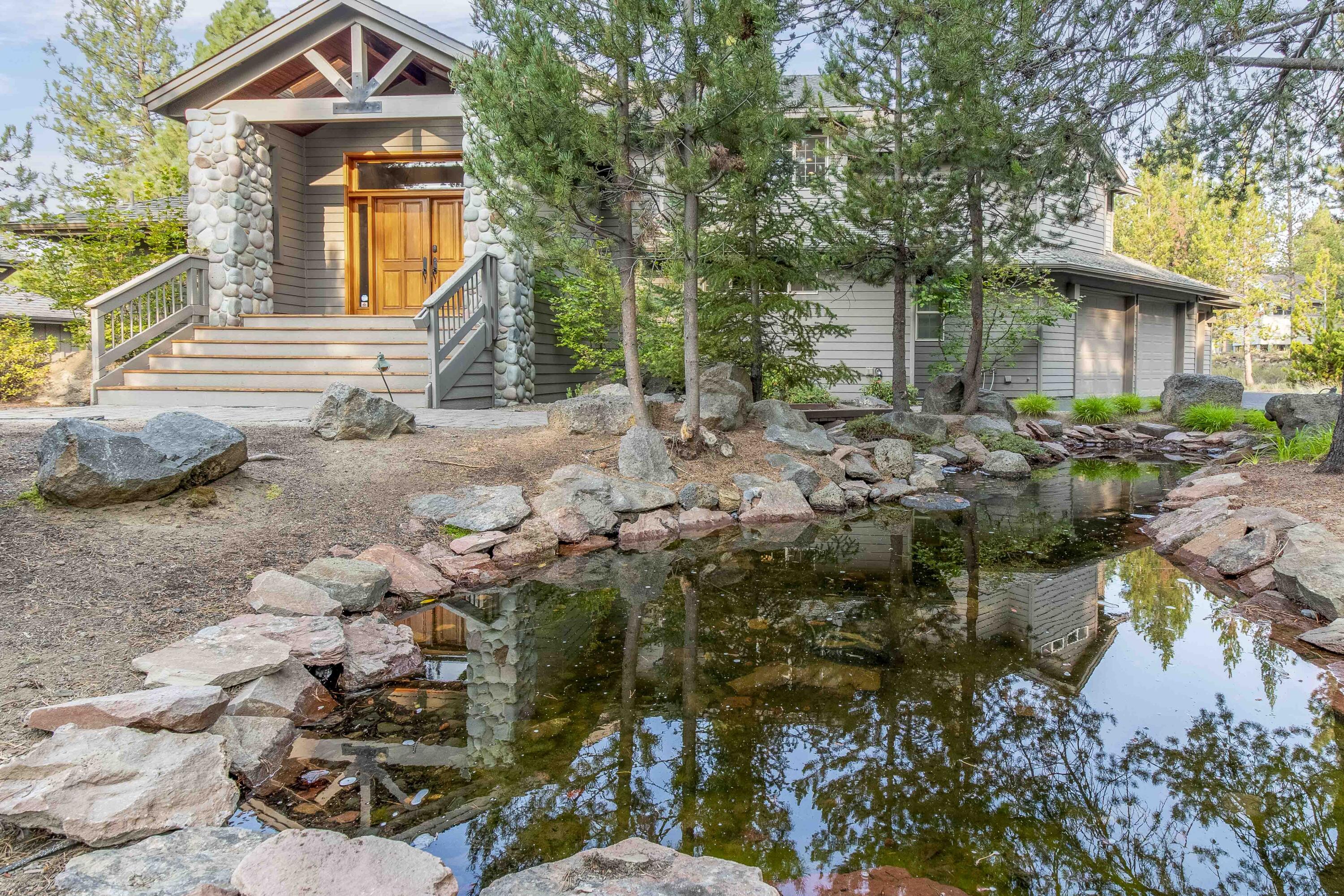 First time on the market! Experience the allure of this custom-built home with a floor plan that seamlessly blends indoor and outdoor living. In the great room, a dramatic river rock gas fireplace & a wall of windows invite the tranquility of nature inside. Spacious kitchen with granite counters & eating bar showcase both style and functionality. A spacious dining area complements the grandeur of the common areas upstairs. The roomy main suite completes the upper level. Downstairs, find 3 add'l Jr Suites plus a bonus room/5th sleeping area with gas fireplace that offers versatility. Outside, you are greeted by a paver entrance & captivating water feature which enhances the surroundings, creating a soothing ambiance. The upper deck offers ample space and a peek-a-boo view of the golf course. A hot tub for true relaxation. A lower shaded deck provides respite on sunny days. Close proximity to Nat'l Forest & trails. Established Rental History! 3-car garage, A/C.