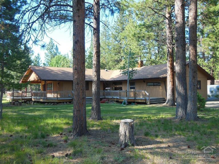 Wonderful setting in the ponderosa pines. A beautiful lot bordering National Forest.2396 Square Feet with Spacious and flexible great room layout. Cozy and comfortable living space with woodstove. Two master suites plus additional bedroom and two den/hobby/bonus rooms for special purposes. Laminate flooring though out living spaces. Lots of windows let the outdoors in while a large covered patio and ample decking supply fantastic outdoor enjoyment. Just minutes from Sisters in a quiet neighborhood.